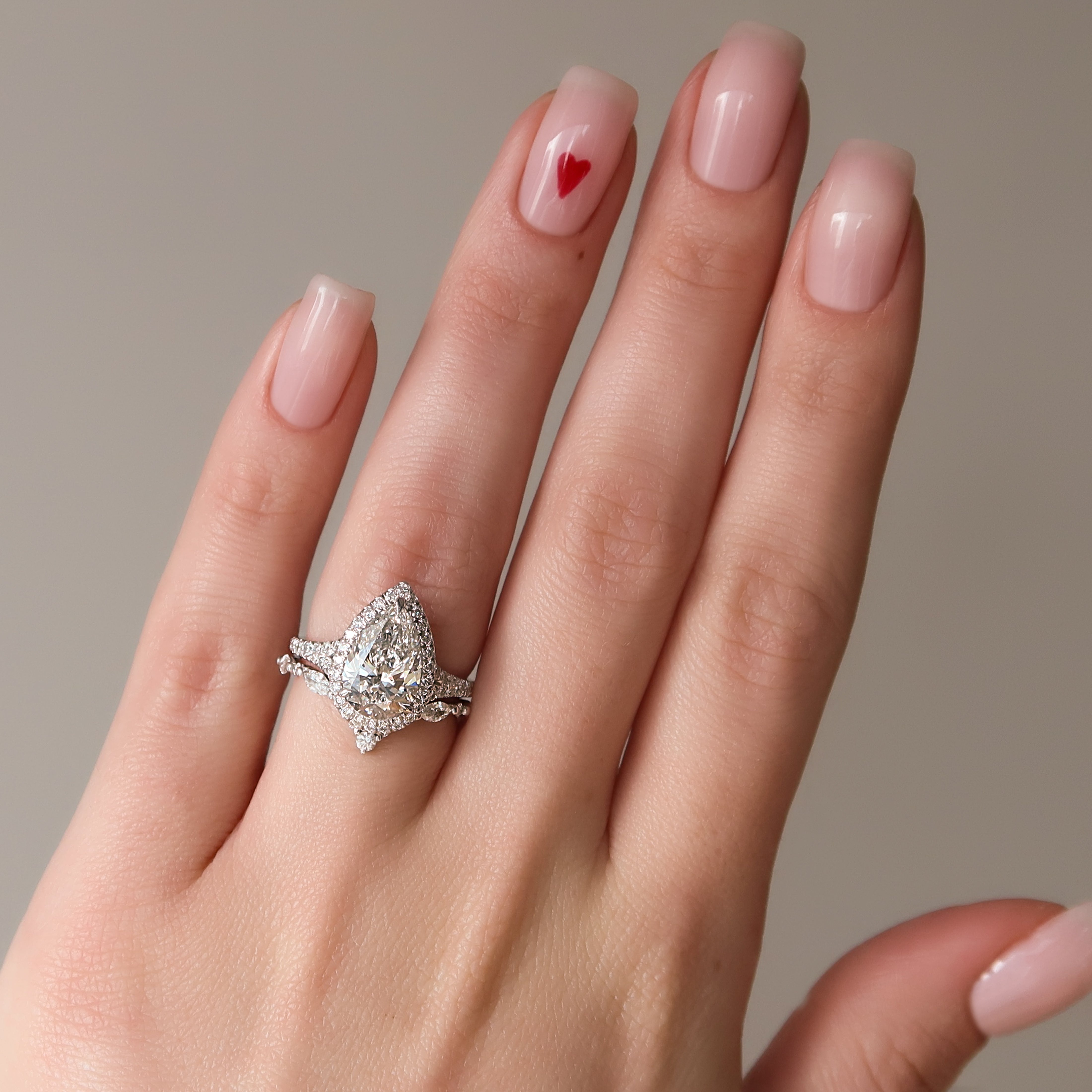 Pear cut CVD diamond halo engagement ring with pave diamond band in white gold