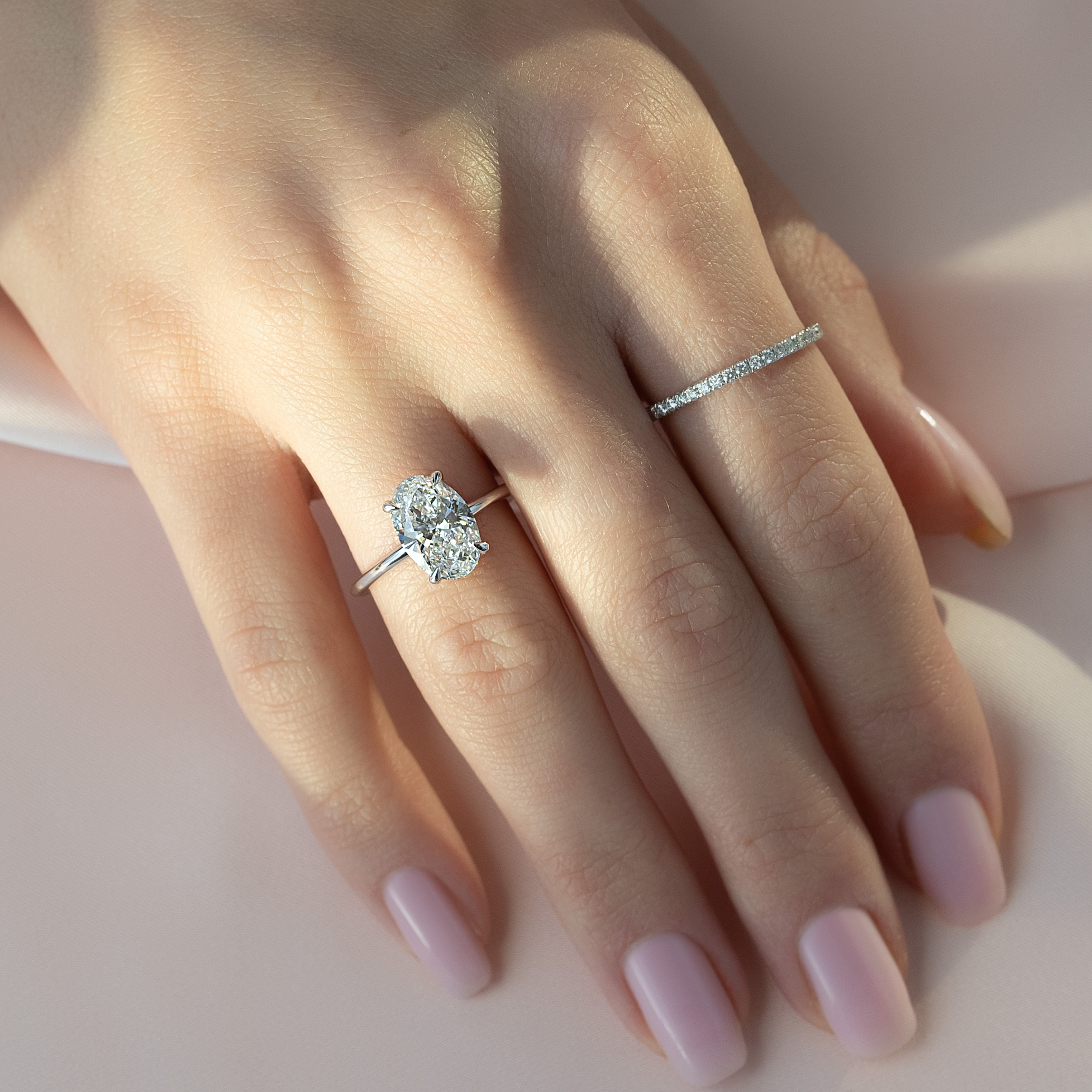 Oval cut CVD diamond hidden halo engagement ring with delicate band in white gold