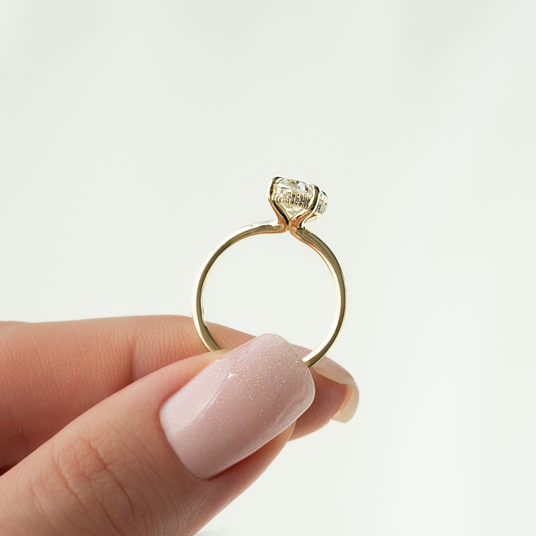 Oval cut CVD diamond hidden halo engagement ring with delicate band in white gold