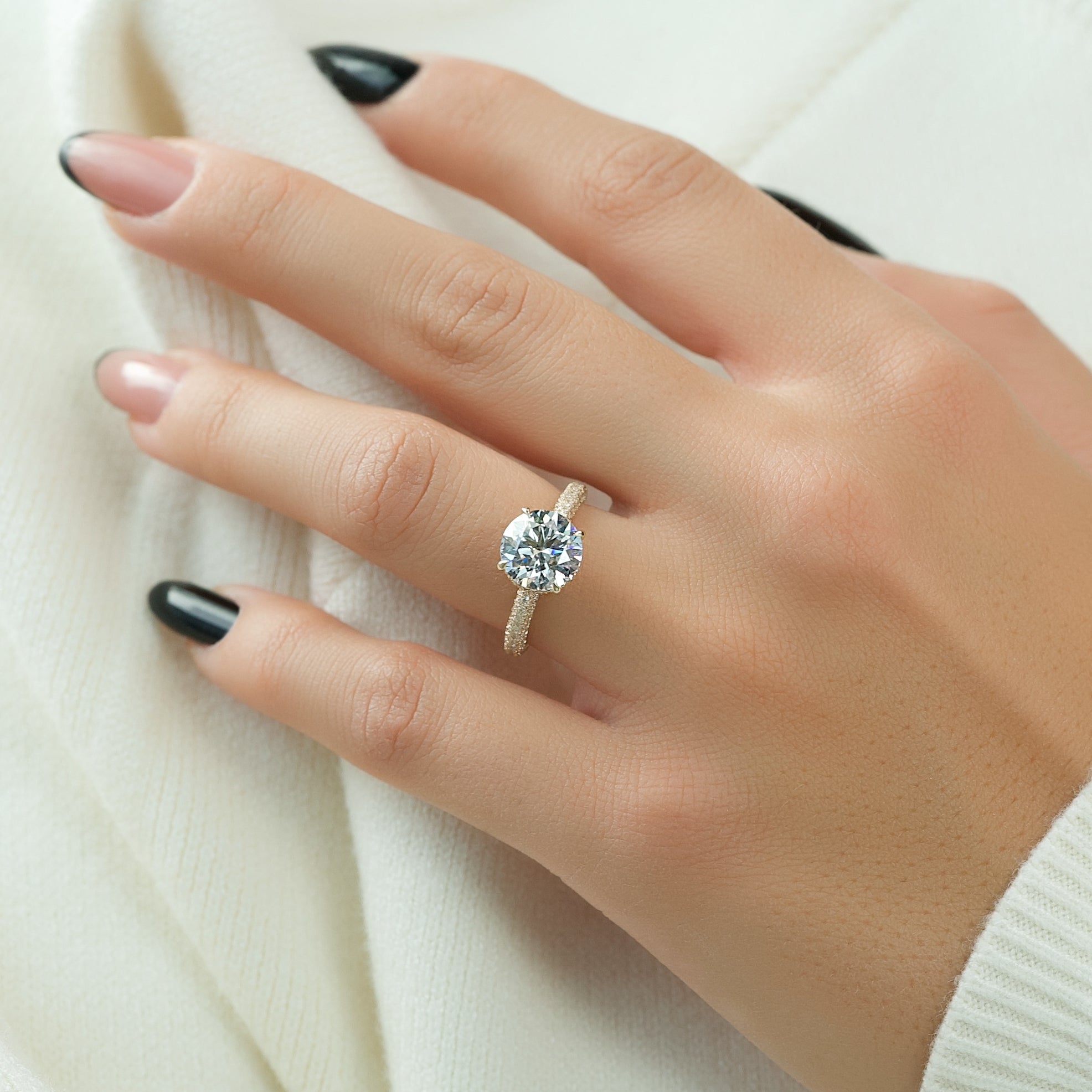 Round cut moissanite engagement ring with hidden halo and pave band in white gold setting