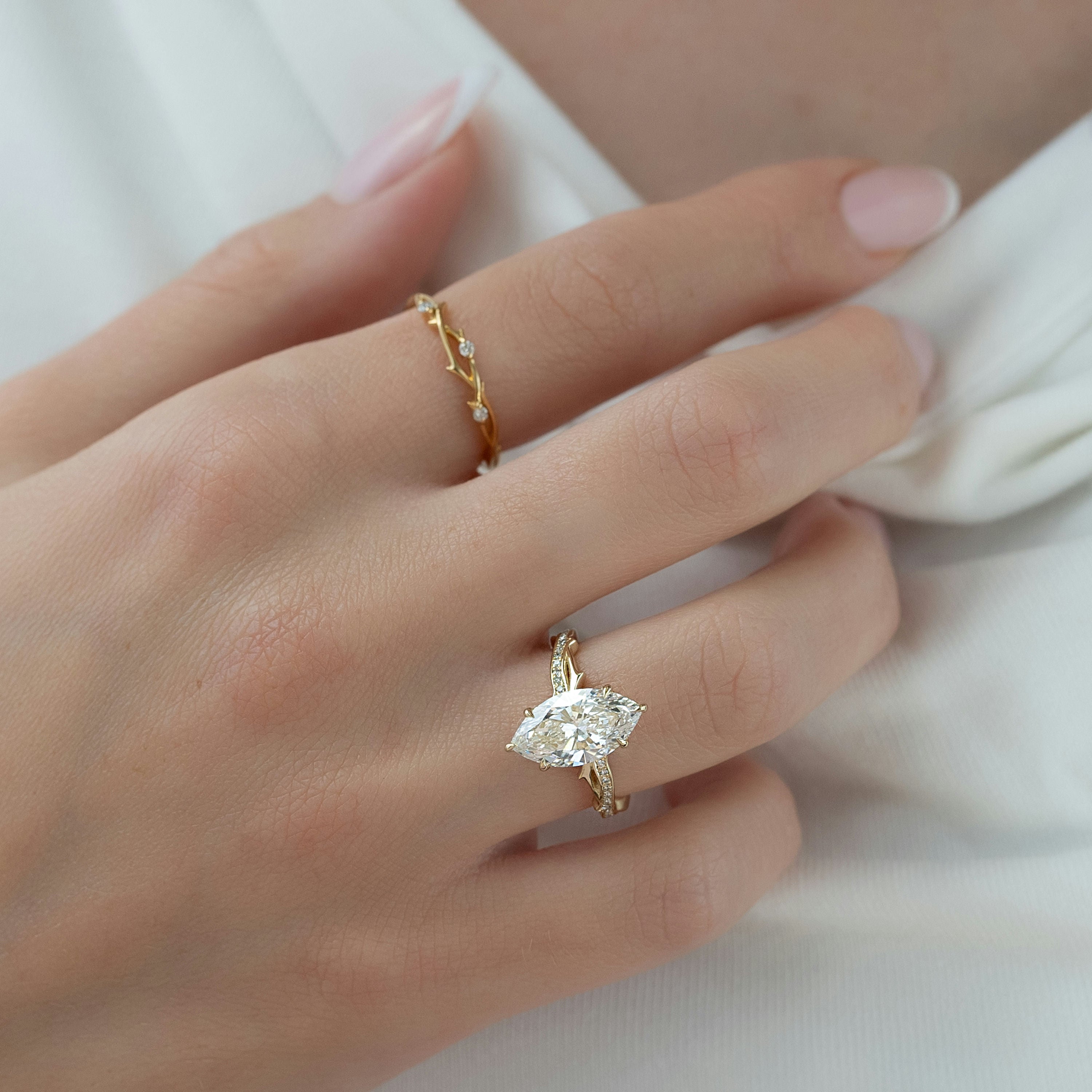 3.6 carat emerald and oval cut moissanite two-stone engagement ring in white gold setting with brilliant sparkle