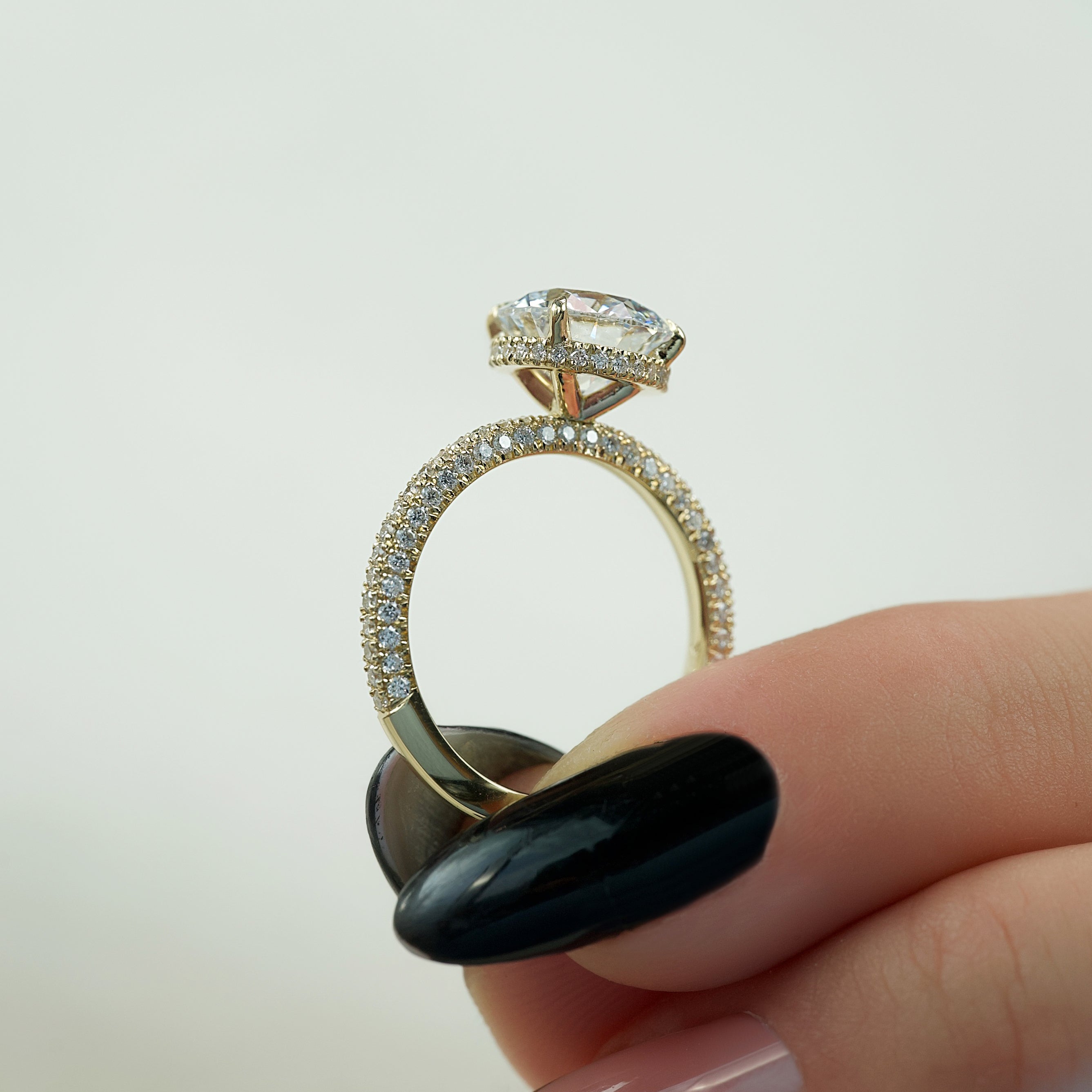 Round cut moissanite engagement ring with hidden halo and pave band in white gold setting