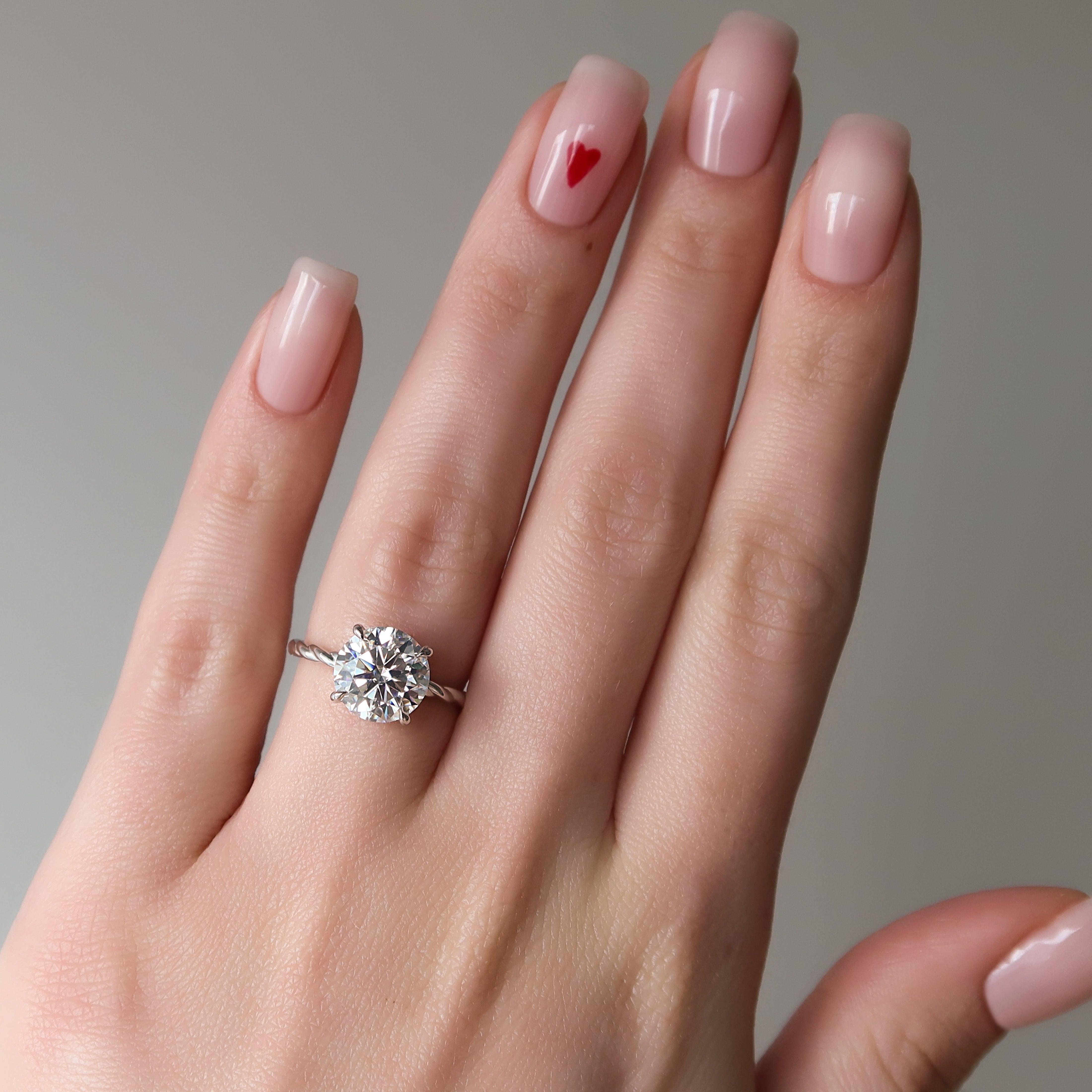 Round cut CVD diamond engagement ring with twisted band in white gold setting