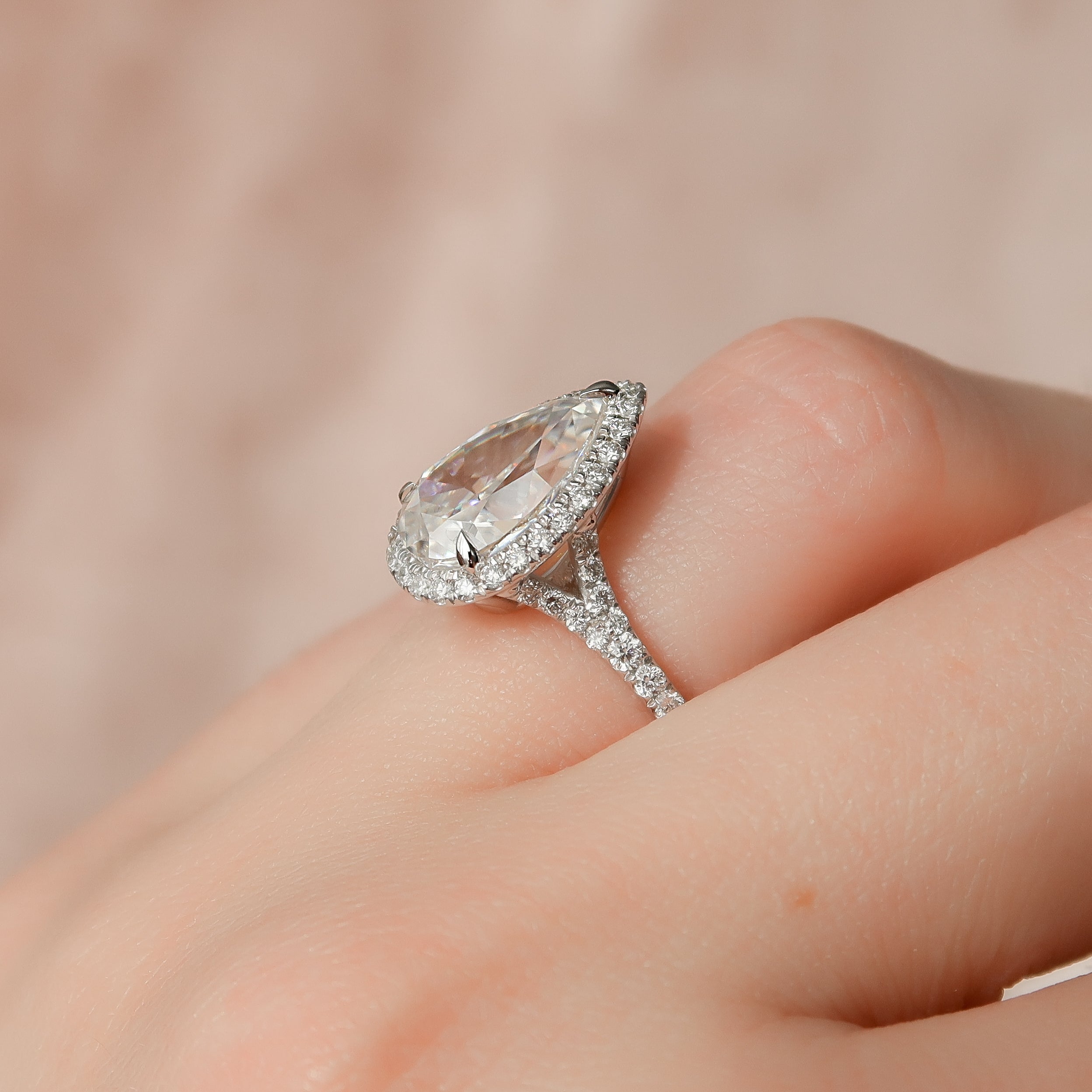 Pear cut CVD diamond halo engagement ring with pave diamond band in white gold