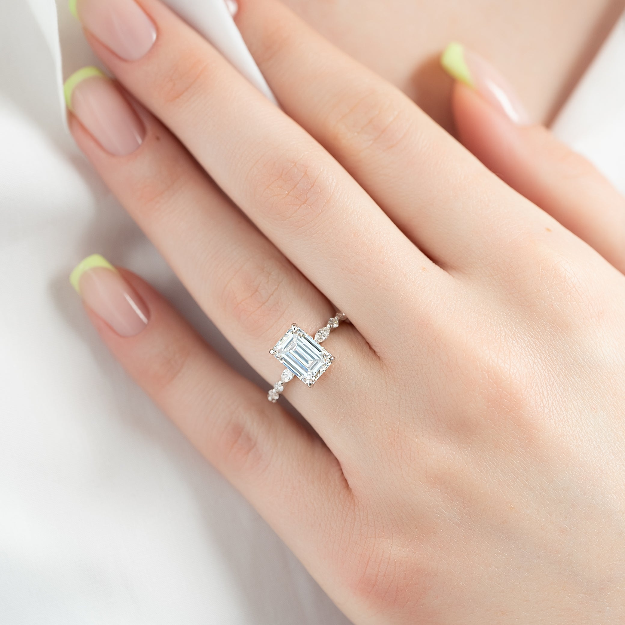 Emerald cut CVD diamond hidden halo engagement ring in white gold setting