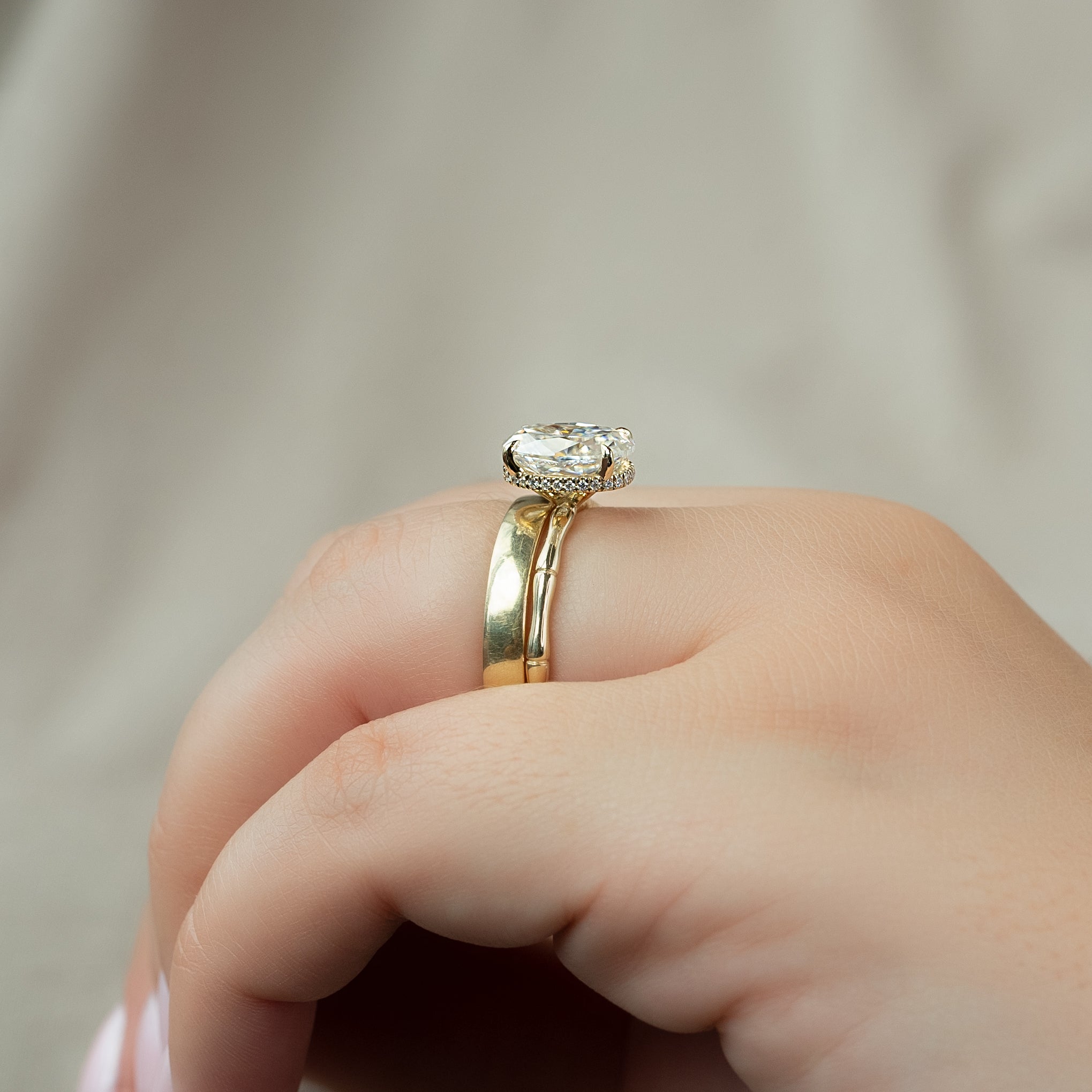 Oval cut CVD diamond engagement ring with hidden halo detail in platinum setting