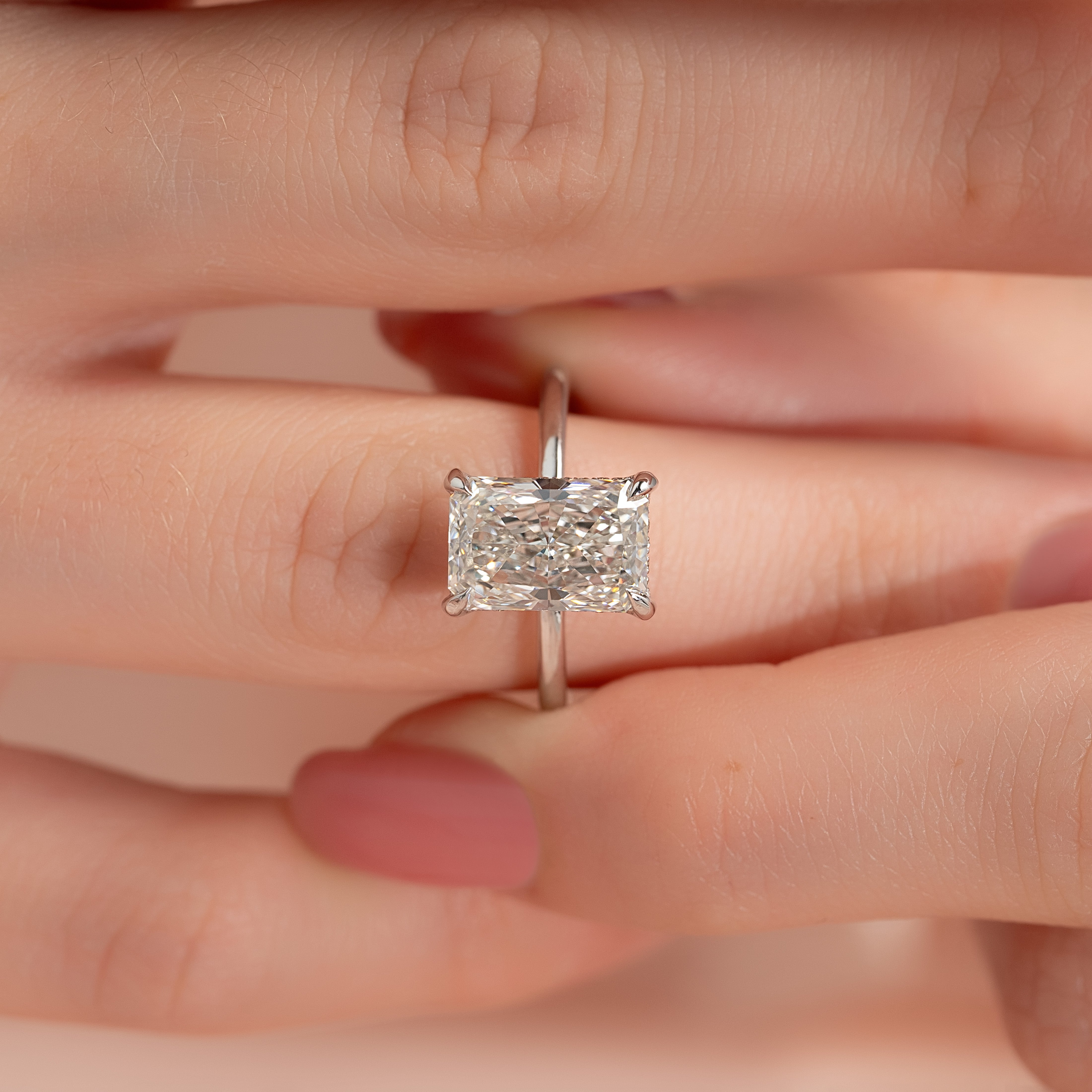 Radiant cut moissanite hidden halo engagement ring in white gold setting