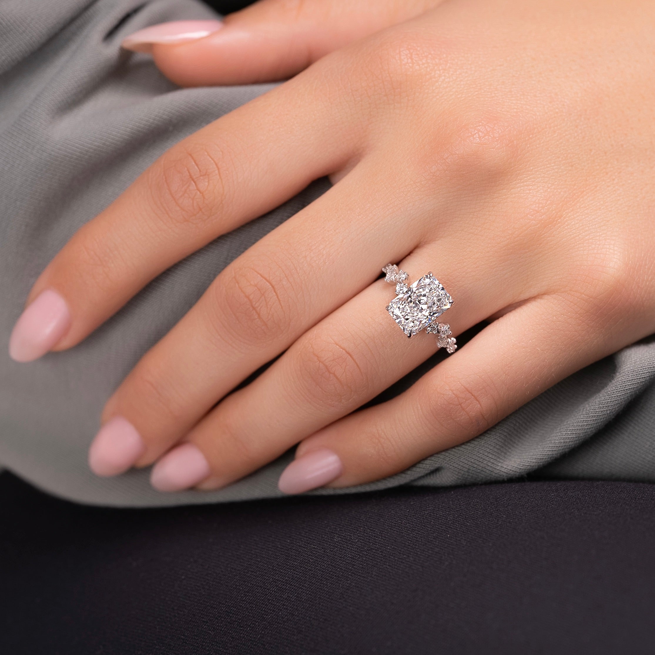 Radiant cut CVD diamond engagement ring with hidden halo and clustered diamond detailing in white gold