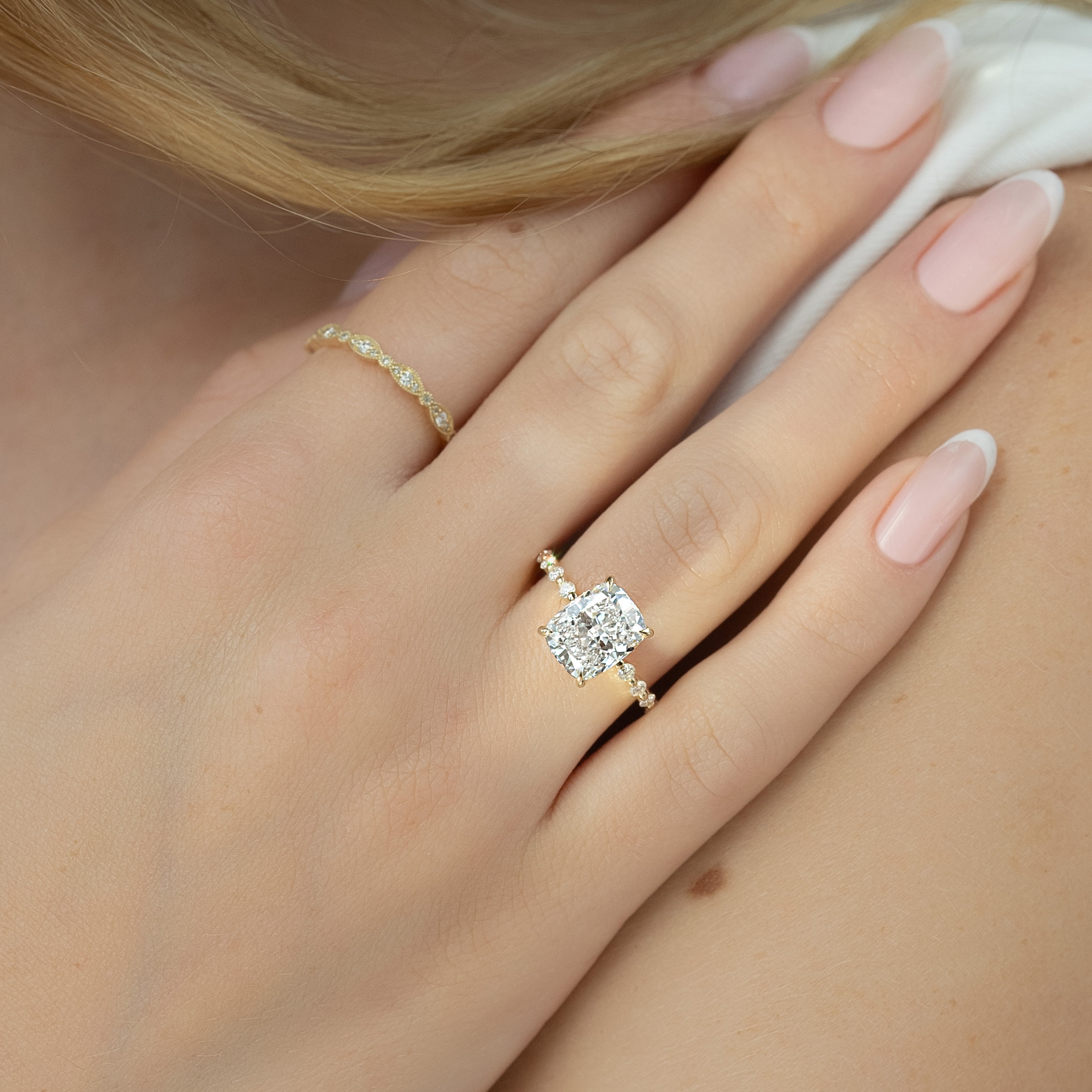 Elongated cushion cut CVD diamond ring with hidden halo and pave style band in platinum