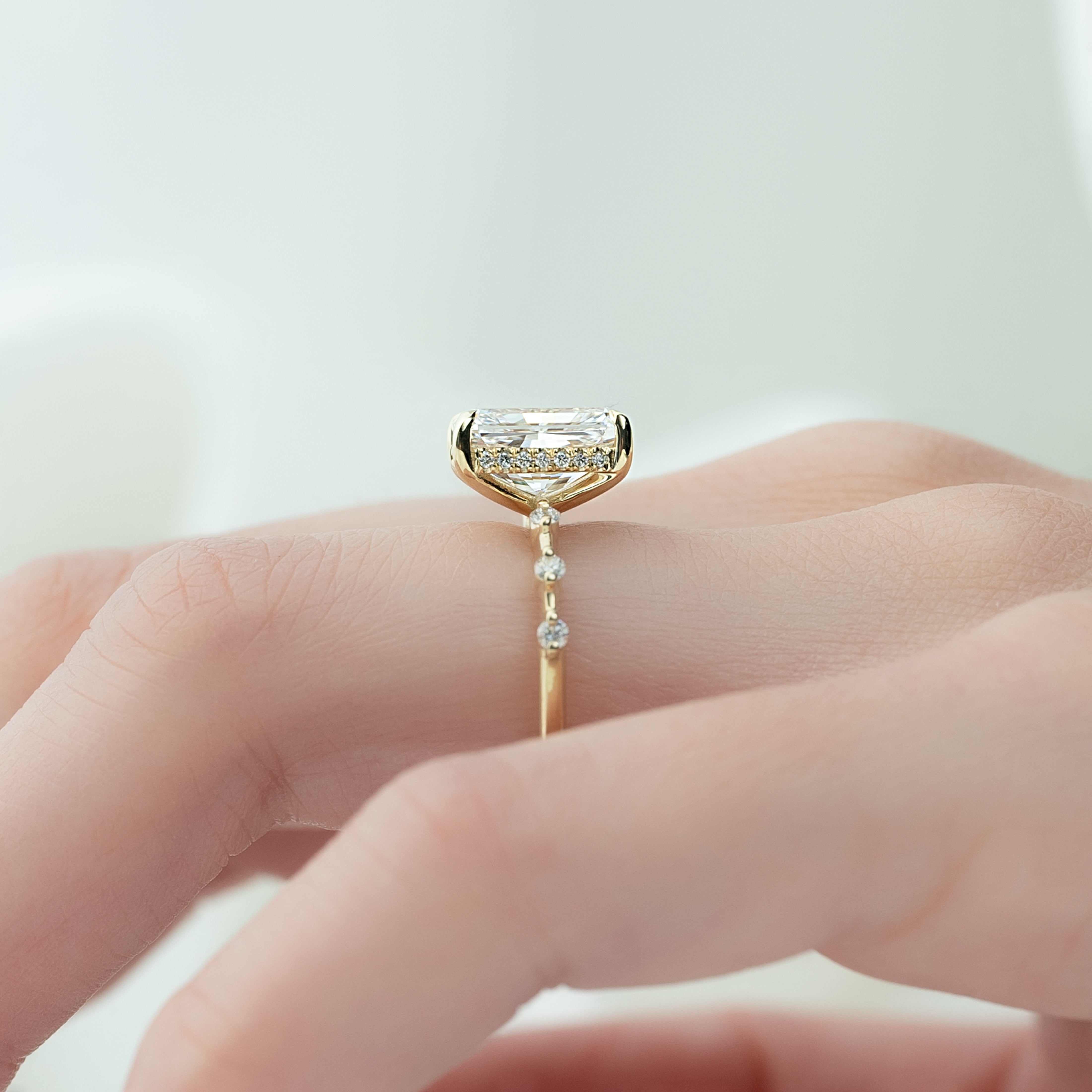 Radiant cut CVD diamond engagement ring with hidden halo in dainty platinum setting