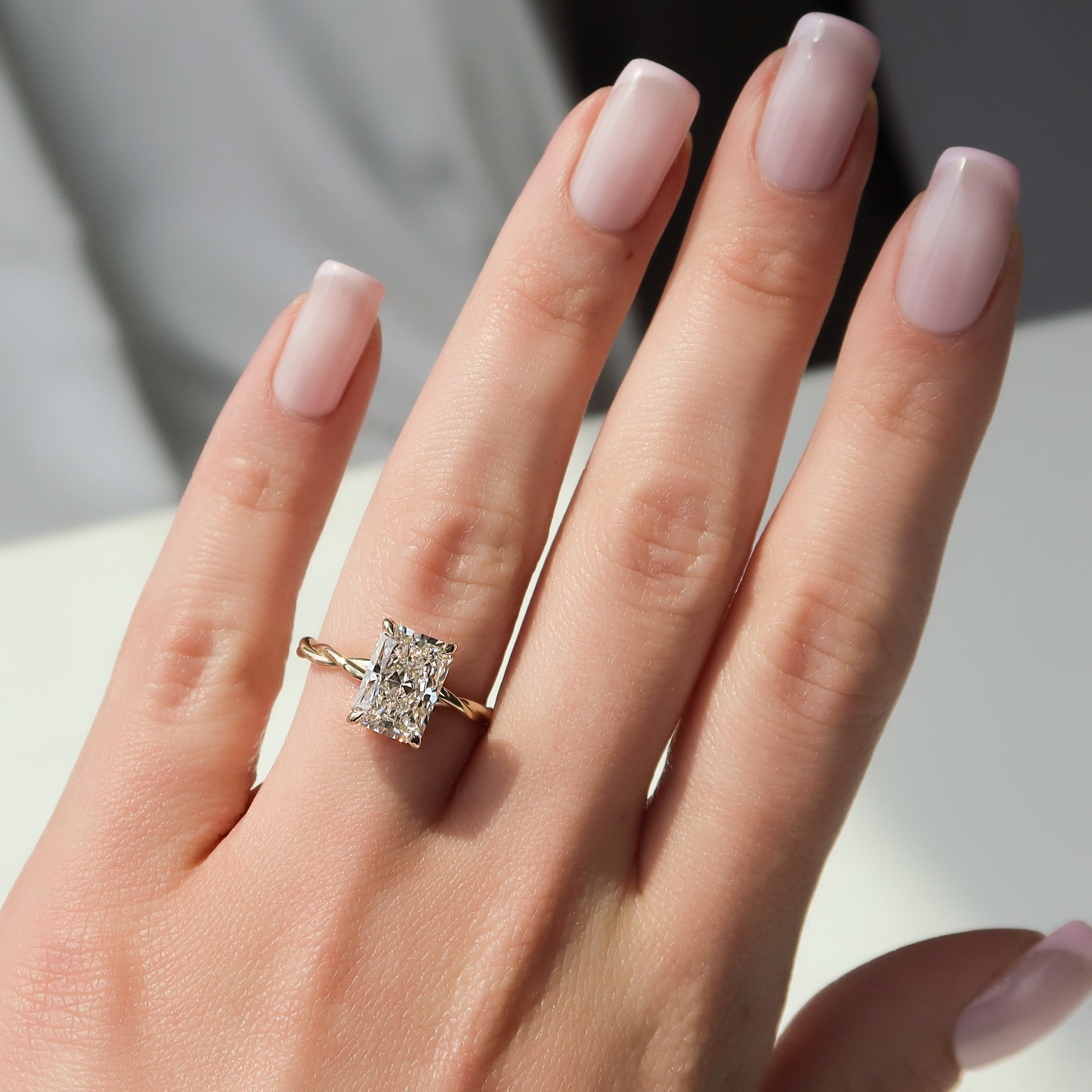 Radiant cut CVD diamond twisted hidden halo engagement ring in white gold setting