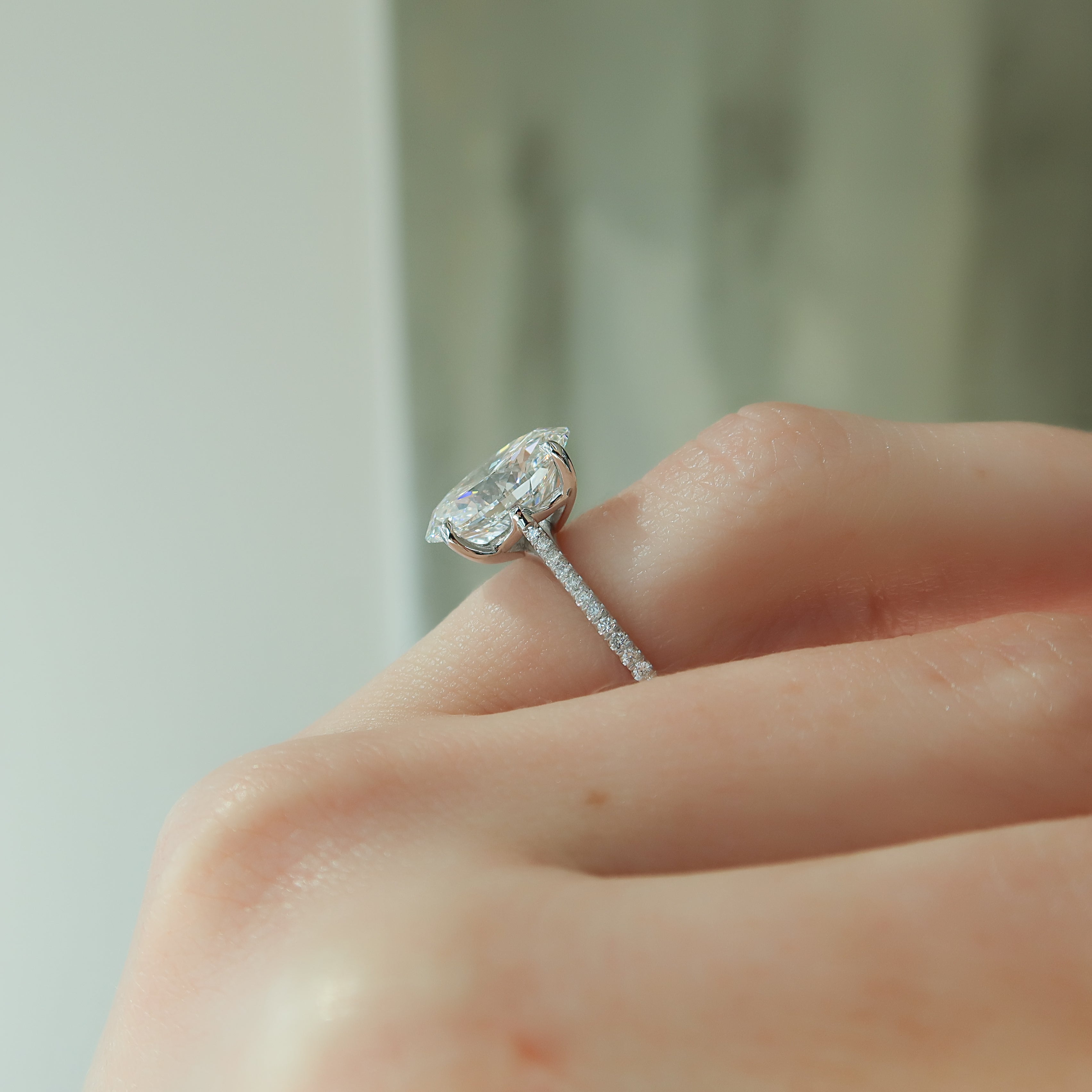 Oval cut CVD diamond engagement ring with pave diamond band in platinum setting