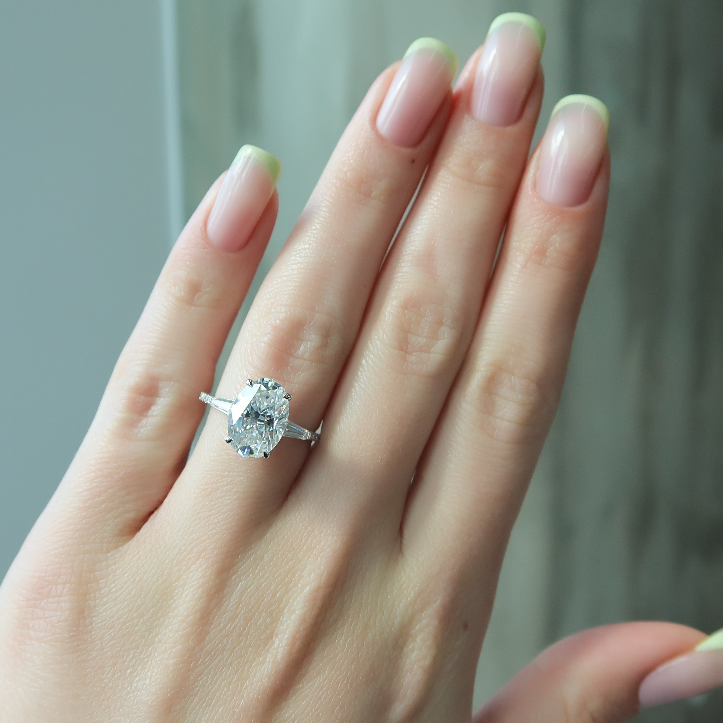 Oval cut CVD diamond three stone engagement ring with side stones in white gold