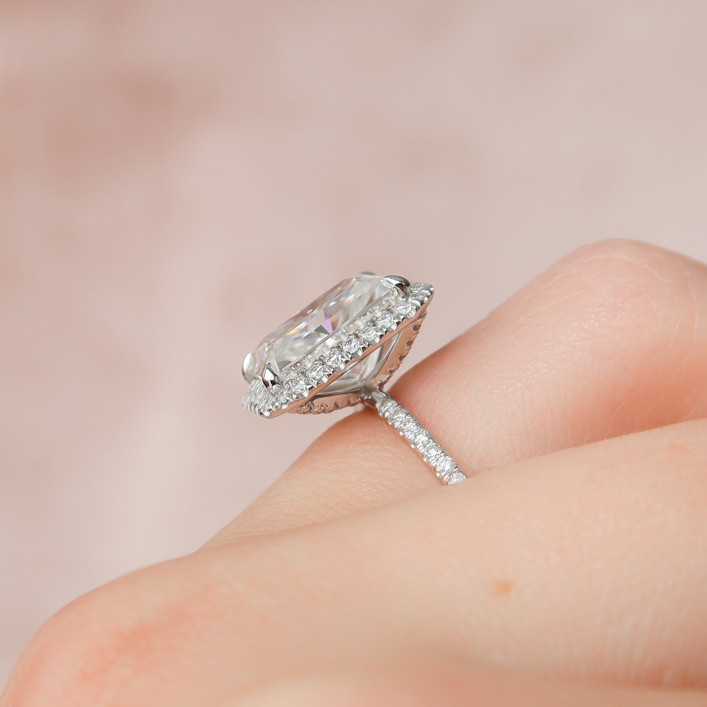 Radiant cut CVD diamond engagement ring with halo setting and pave band, crafted in a modern elegant style