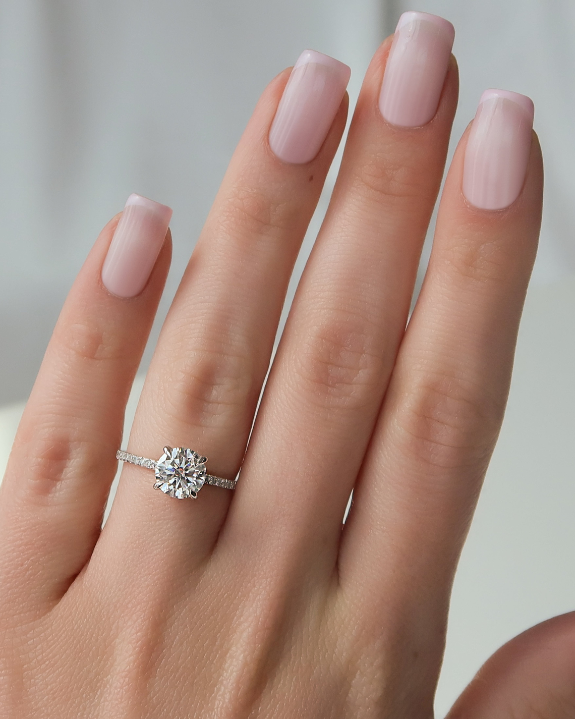 Round cut CVD diamond engagement ring with hidden halo and pave setting in white gold