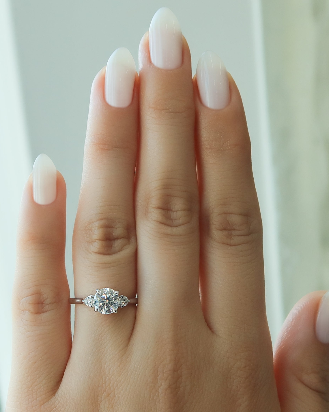 Round cut CVD diamond three-stone engagement ring in platinum setting