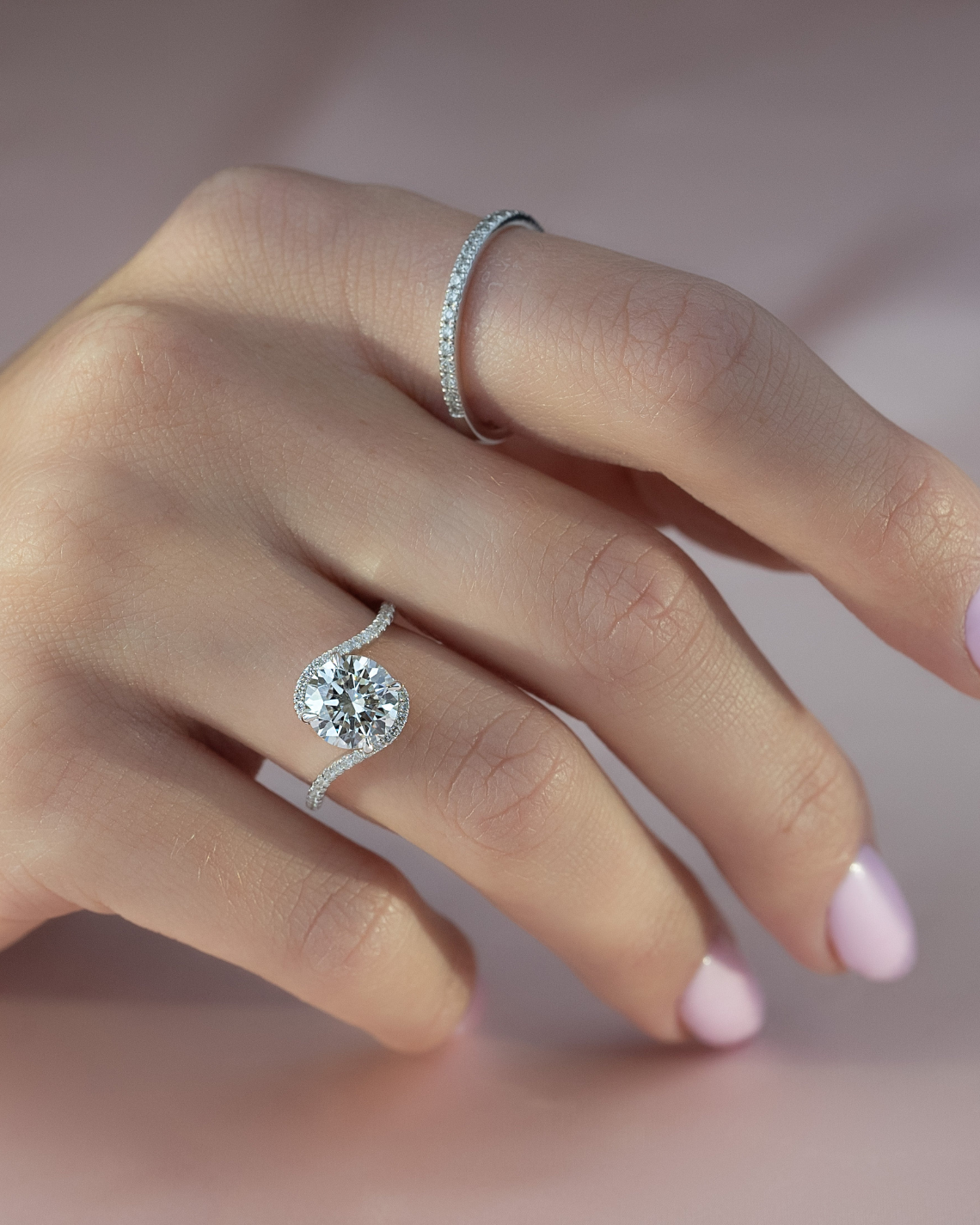 Round cut moissanite engagement ring in bypass setting with white gold band