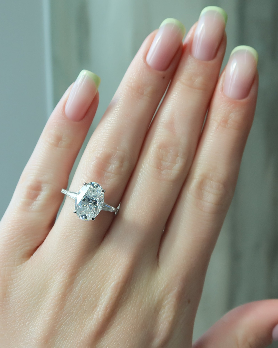 Oval cut CVD diamond three stone engagement ring with side stones in white gold