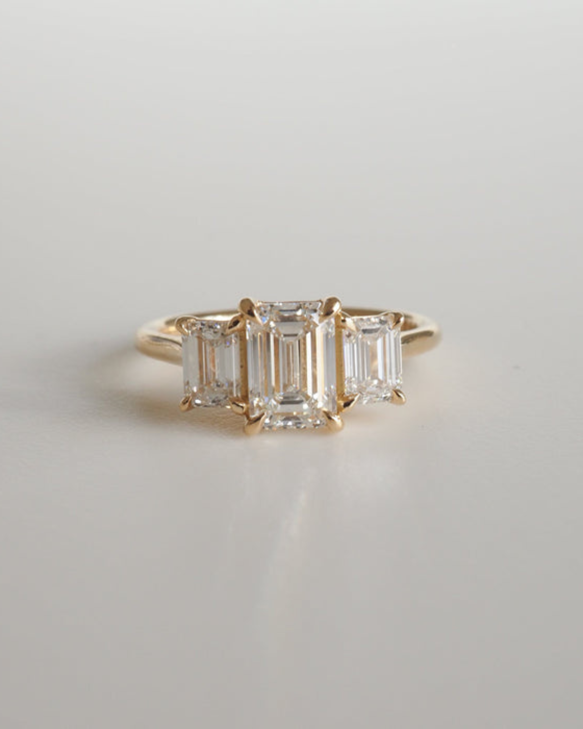 2.05 carat emerald cut moissanite three-stone engagement ring in white gold setting