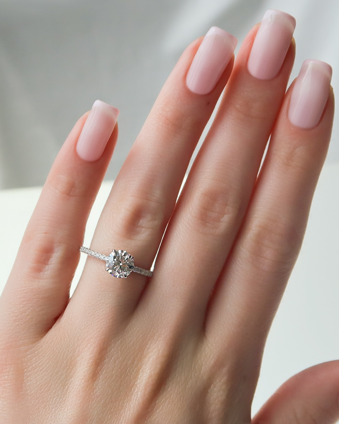 Round cut CVD diamond engagement ring with delicate pave diamond band in platinum