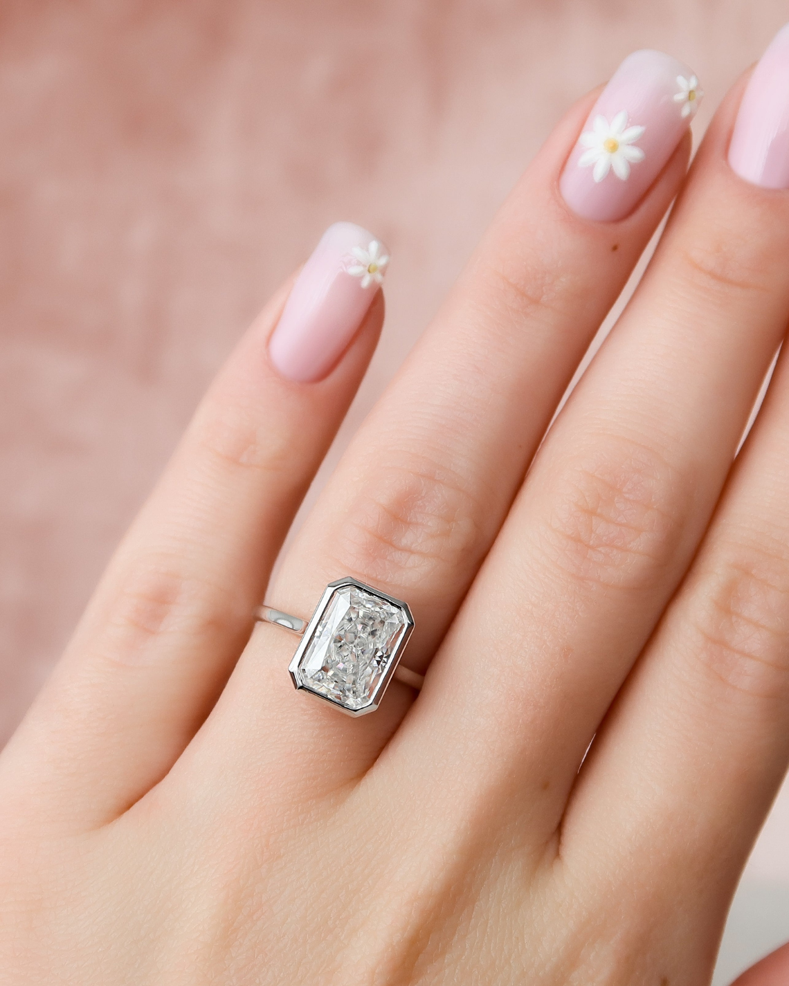 Radiant cut CVD diamond bezel set engagement ring with hidden halo in platinum setting