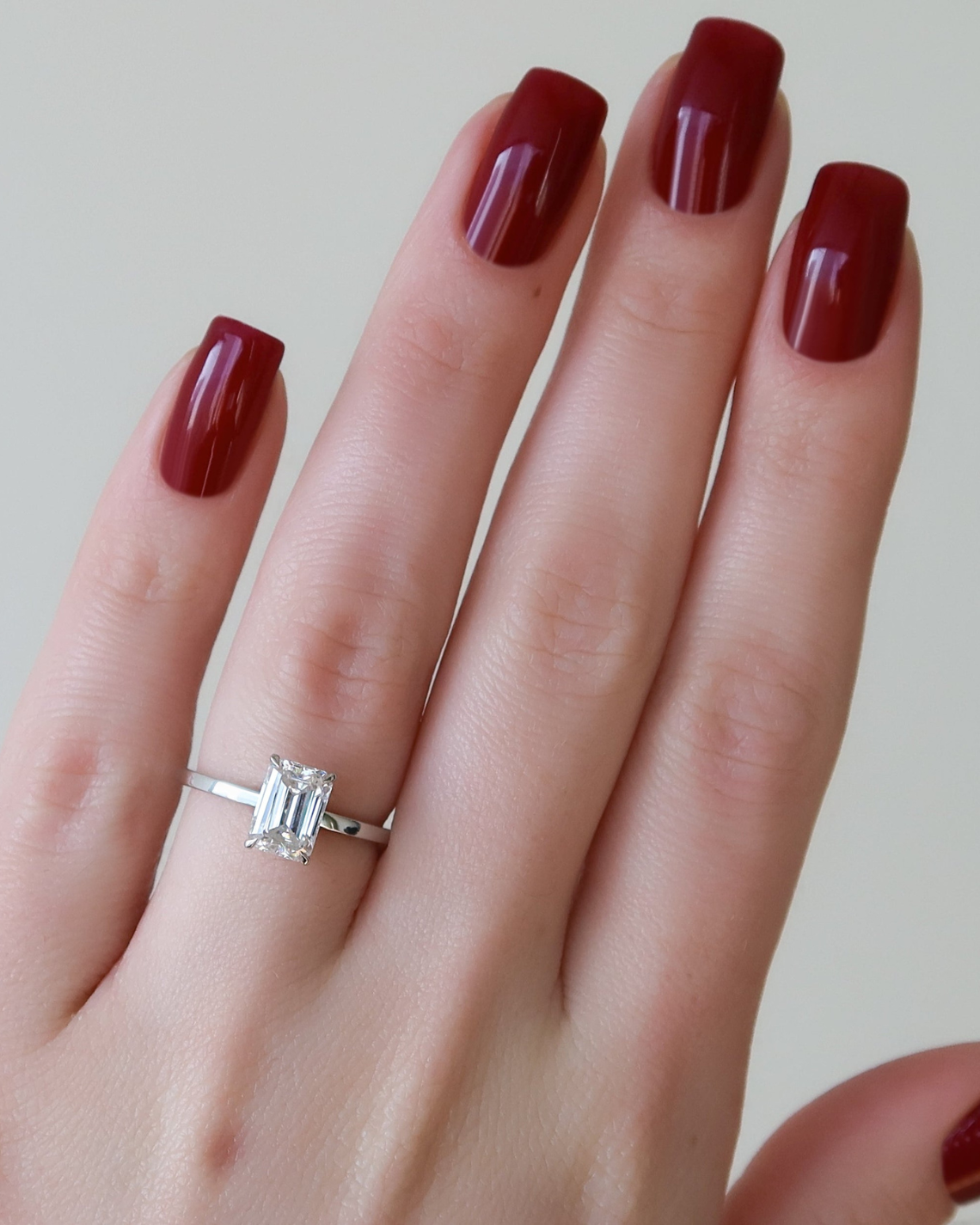 Emerald cut moissanite solitaire engagement ring in platinum setting