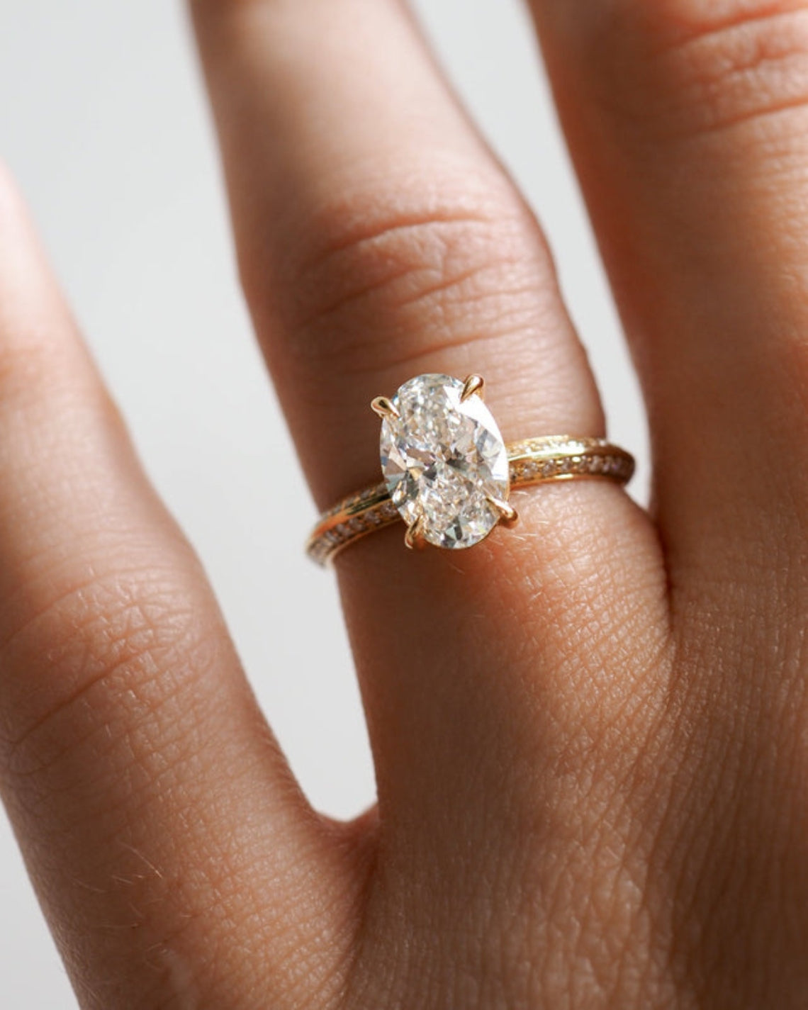 1.53 to 2.50 carat oval shaped lab-grown CVD diamond engagement ring with a shimmering pave setting in a modern elegant design