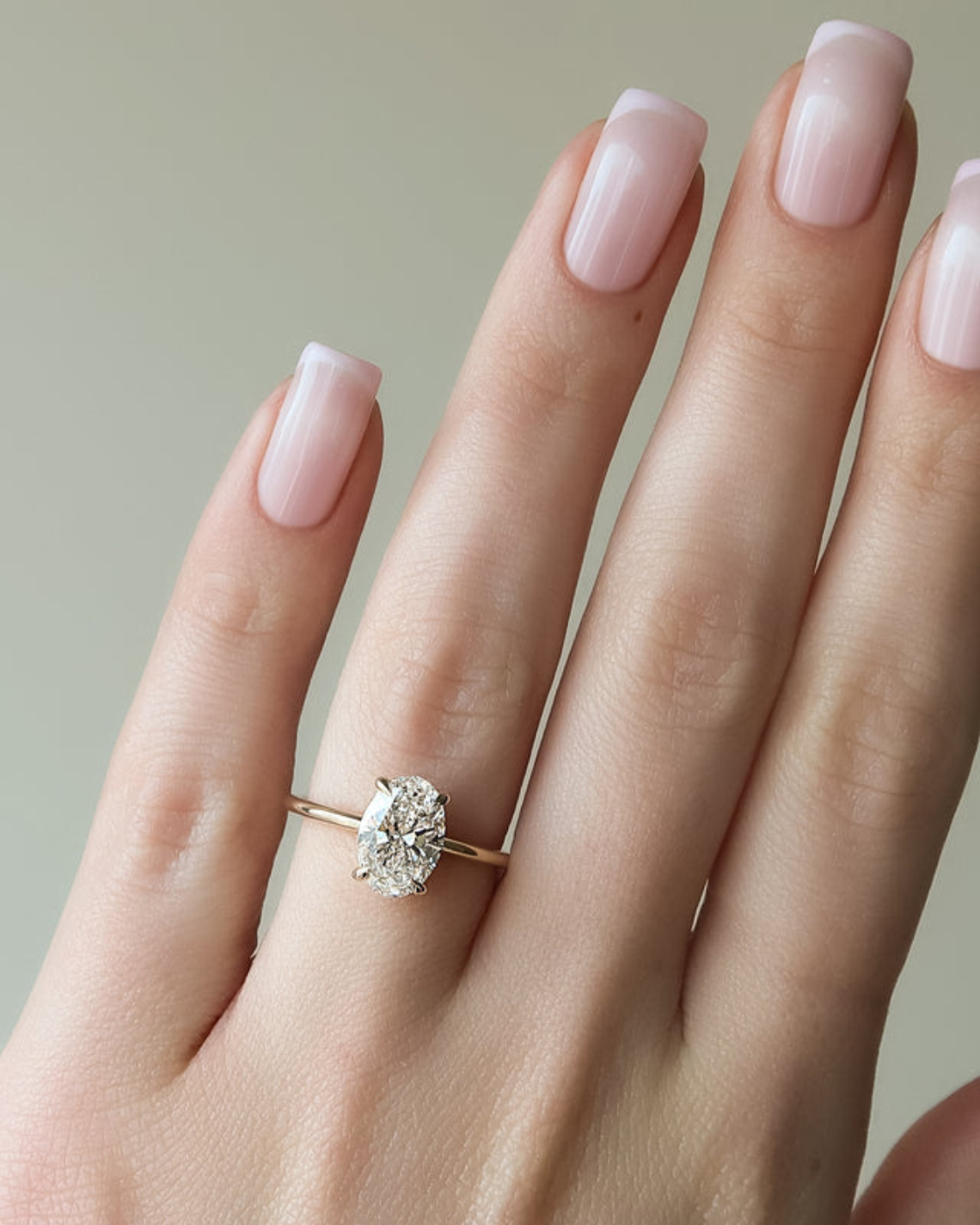 Oval cut CVD diamond hidden halo engagement ring with delicate band in white gold
