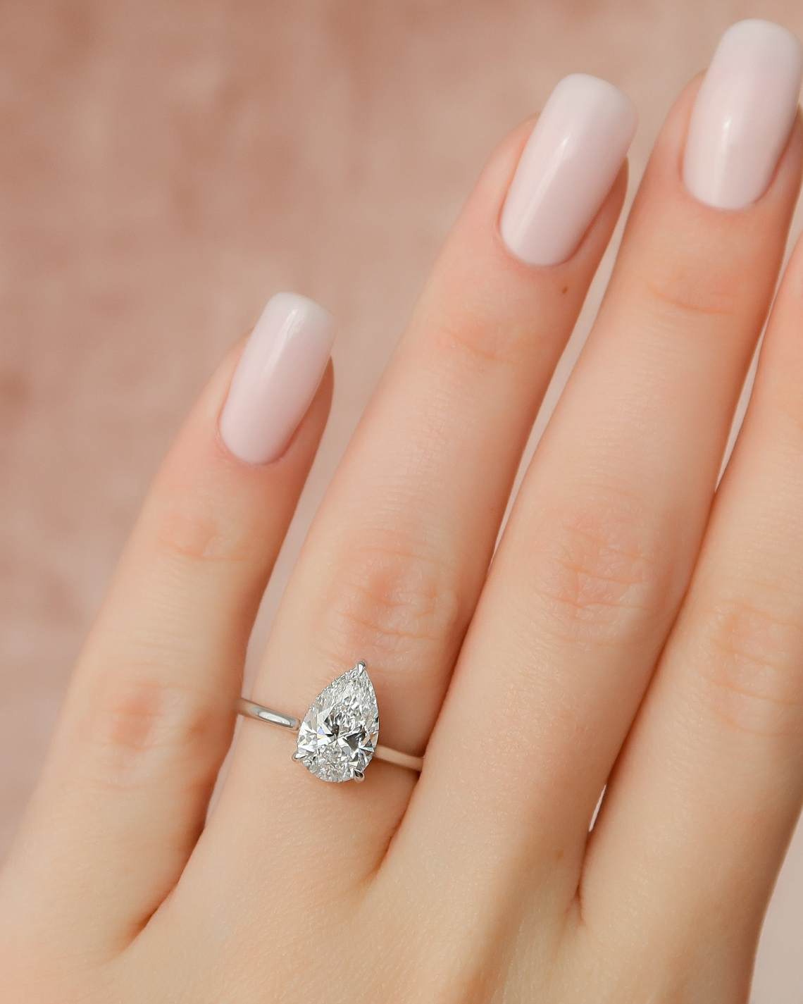 Pear cut CVD diamond engagement ring with hidden halo in white gold setting