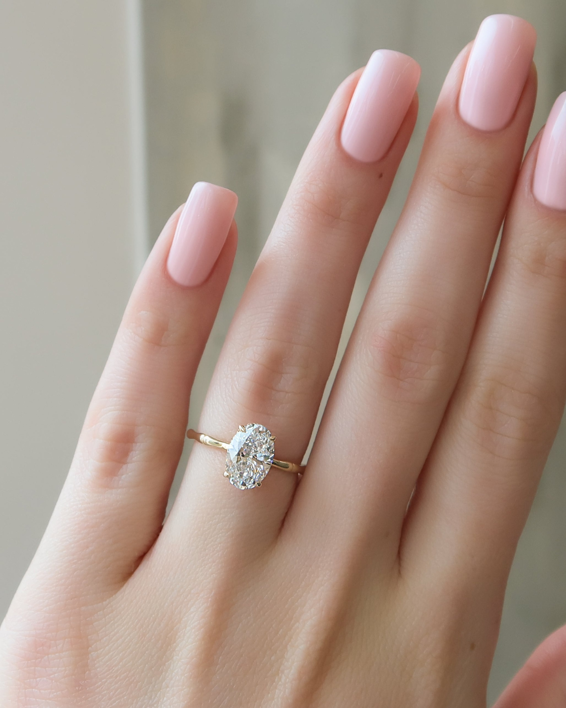 Oval cut CVD diamond engagement ring with hidden halo detail in platinum setting