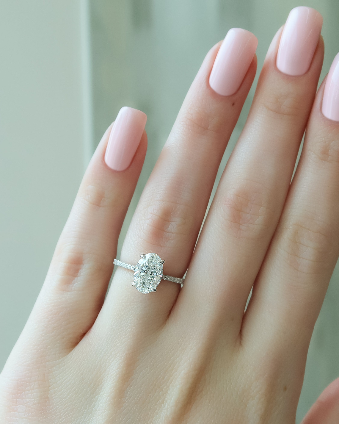 Oval cut CVD diamond engagement ring with pave diamond band in platinum setting