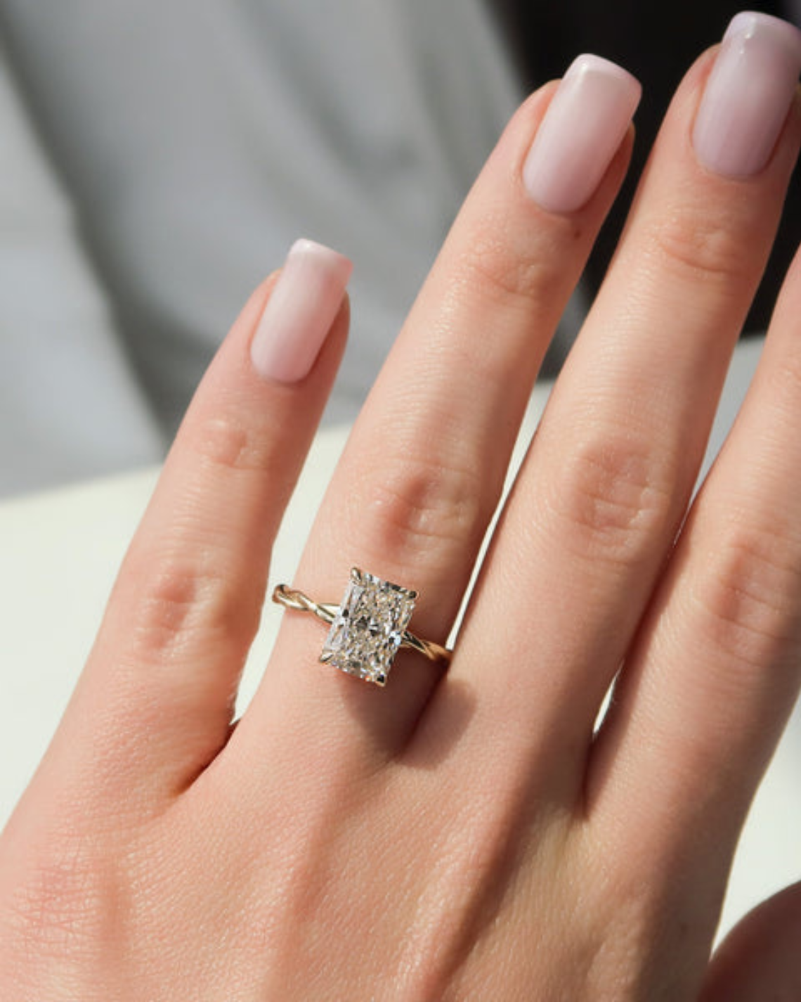 Radiant cut CVD diamond twisted hidden halo engagement ring in white gold setting