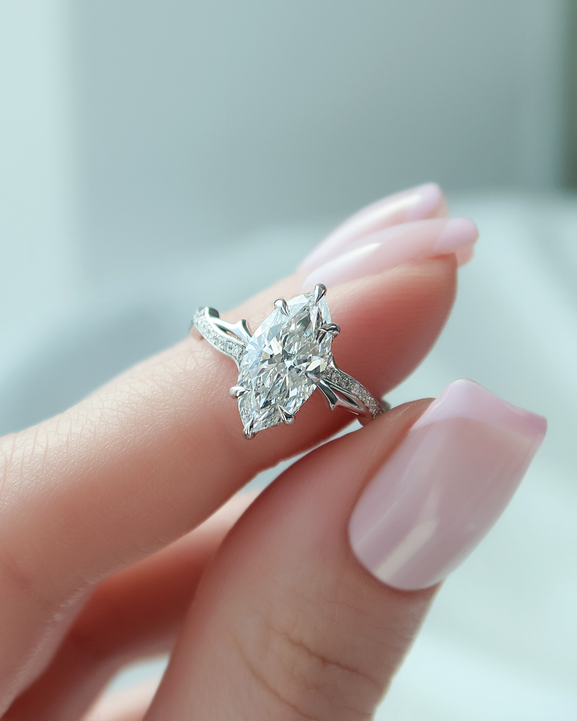 3.6 carat emerald and oval cut moissanite two-stone engagement ring in white gold setting with brilliant sparkle