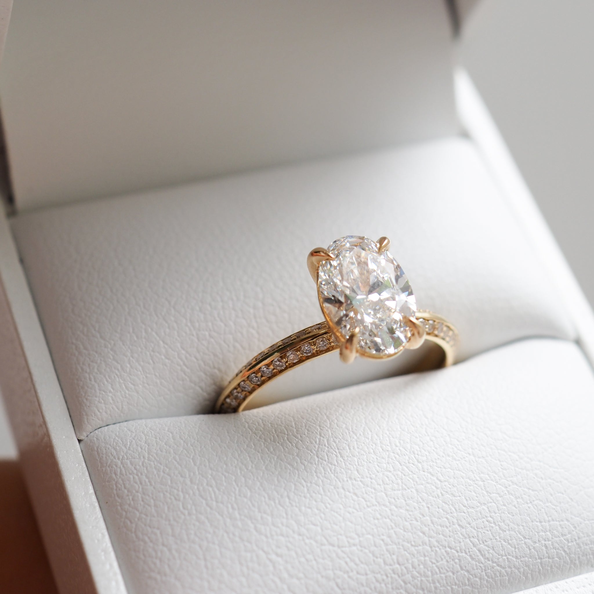 1.53 to 2.50 carat oval shaped lab-grown CVD diamond engagement ring with a shimmering pave setting in a modern elegant design