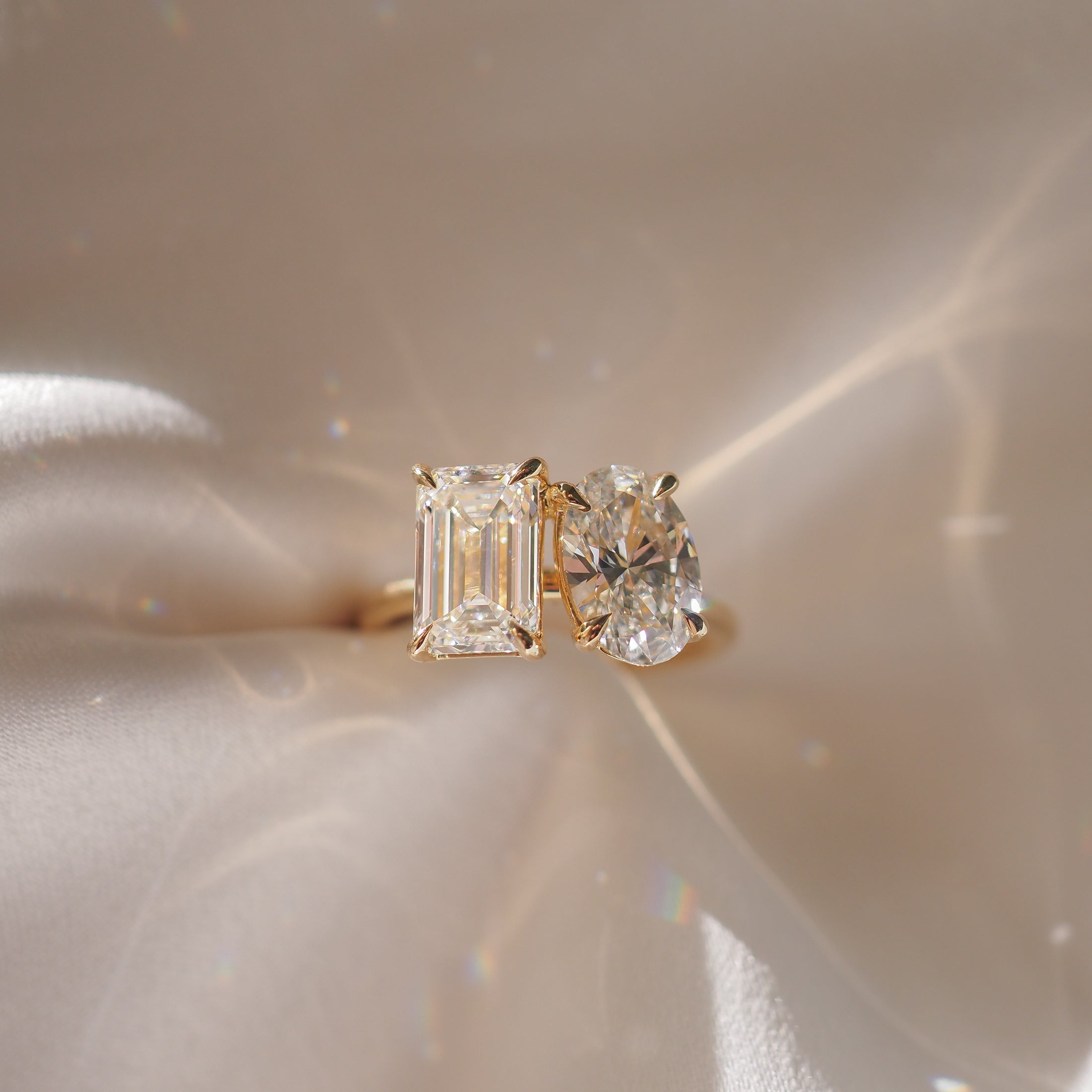 3.6 carat emerald and oval cut moissanite two-stone engagement ring in white gold setting
