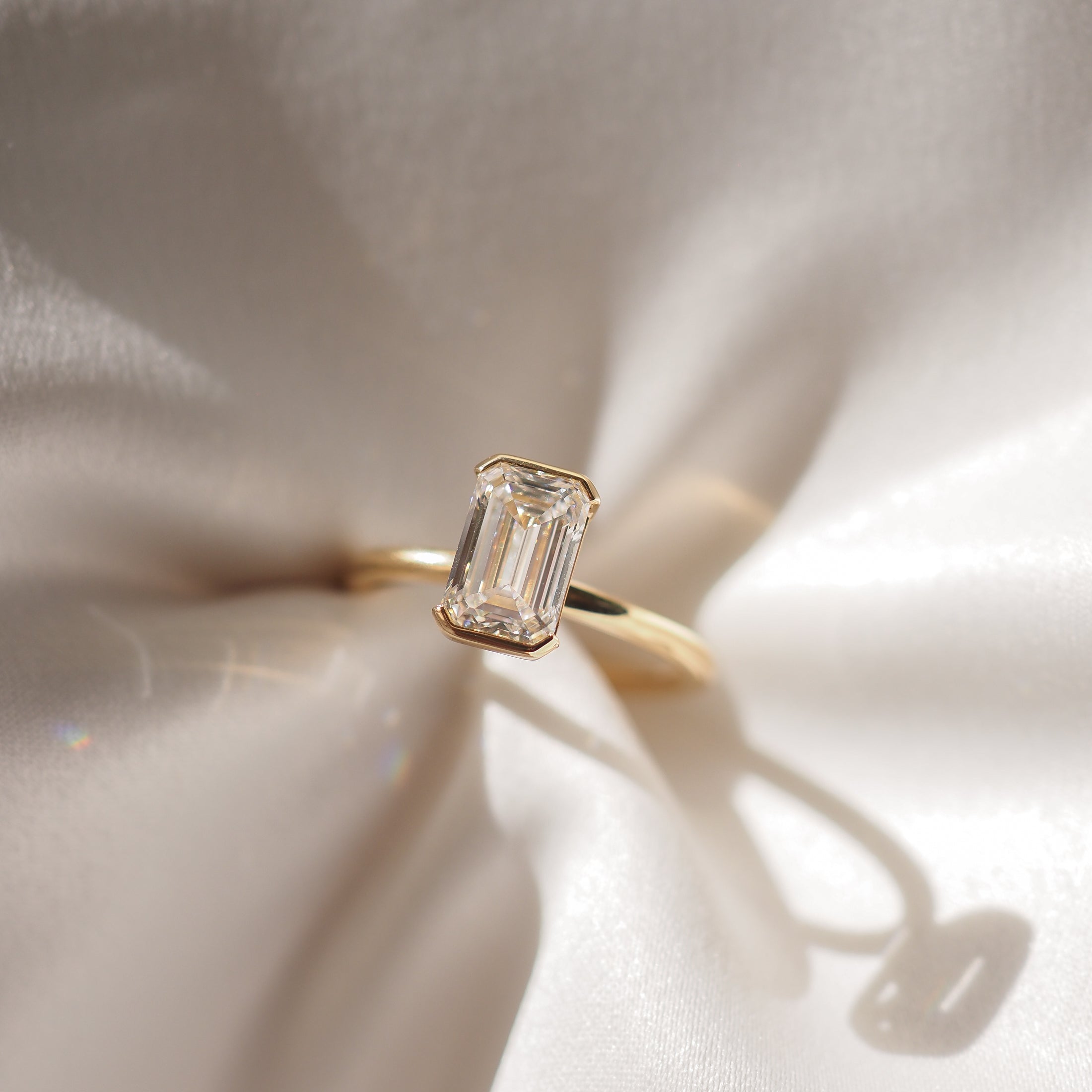 Emerald cut moissanite bezel solitaire engagement ring in platinum setting, 1.50-2.50 CT