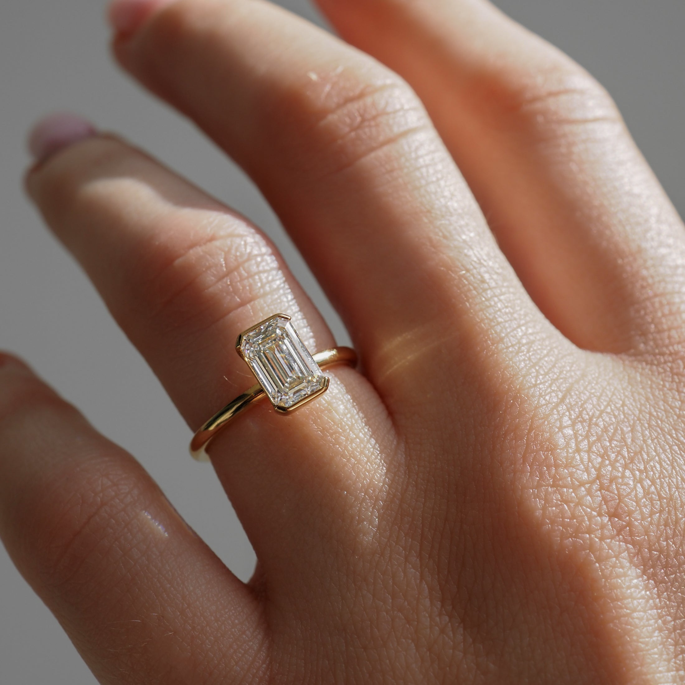 Emerald cut moissanite bezel solitaire engagement ring in platinum setting, 1.50-2.50 CT