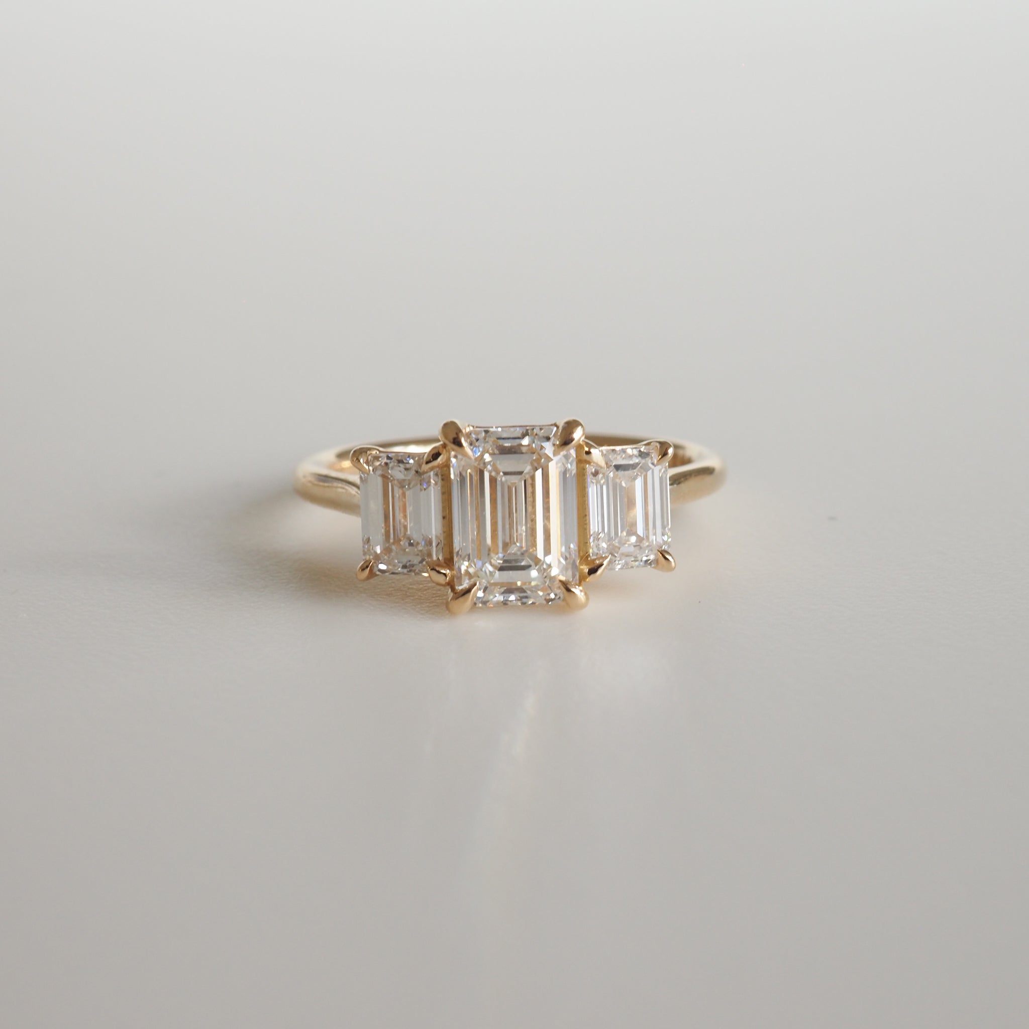 2.05 carat emerald cut moissanite three-stone engagement ring in white gold setting
