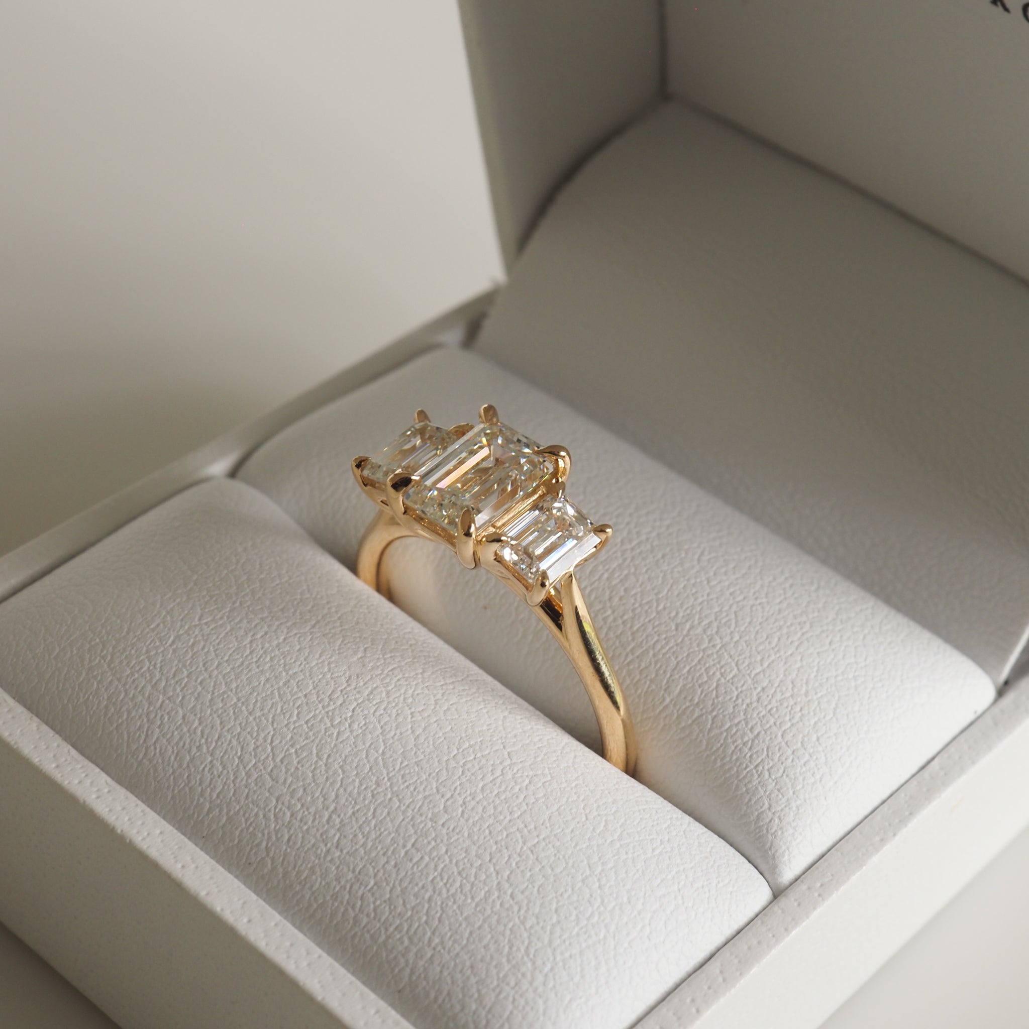 2.05 carat emerald cut moissanite three-stone engagement ring in white gold setting