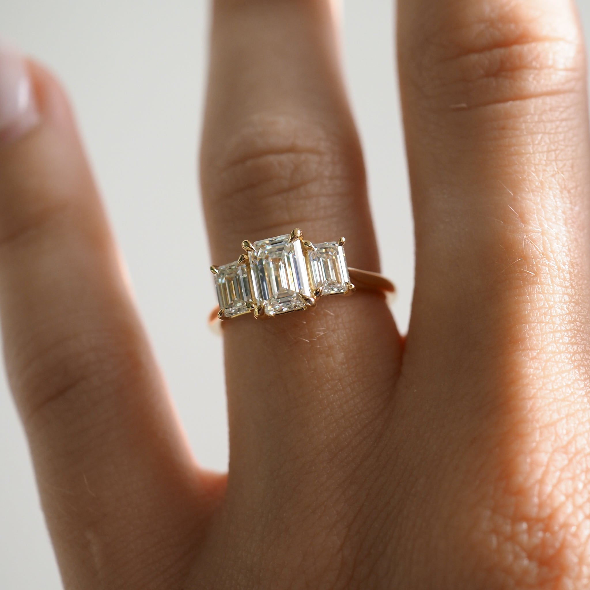 2.05 carat emerald cut moissanite three-stone engagement ring in white gold setting