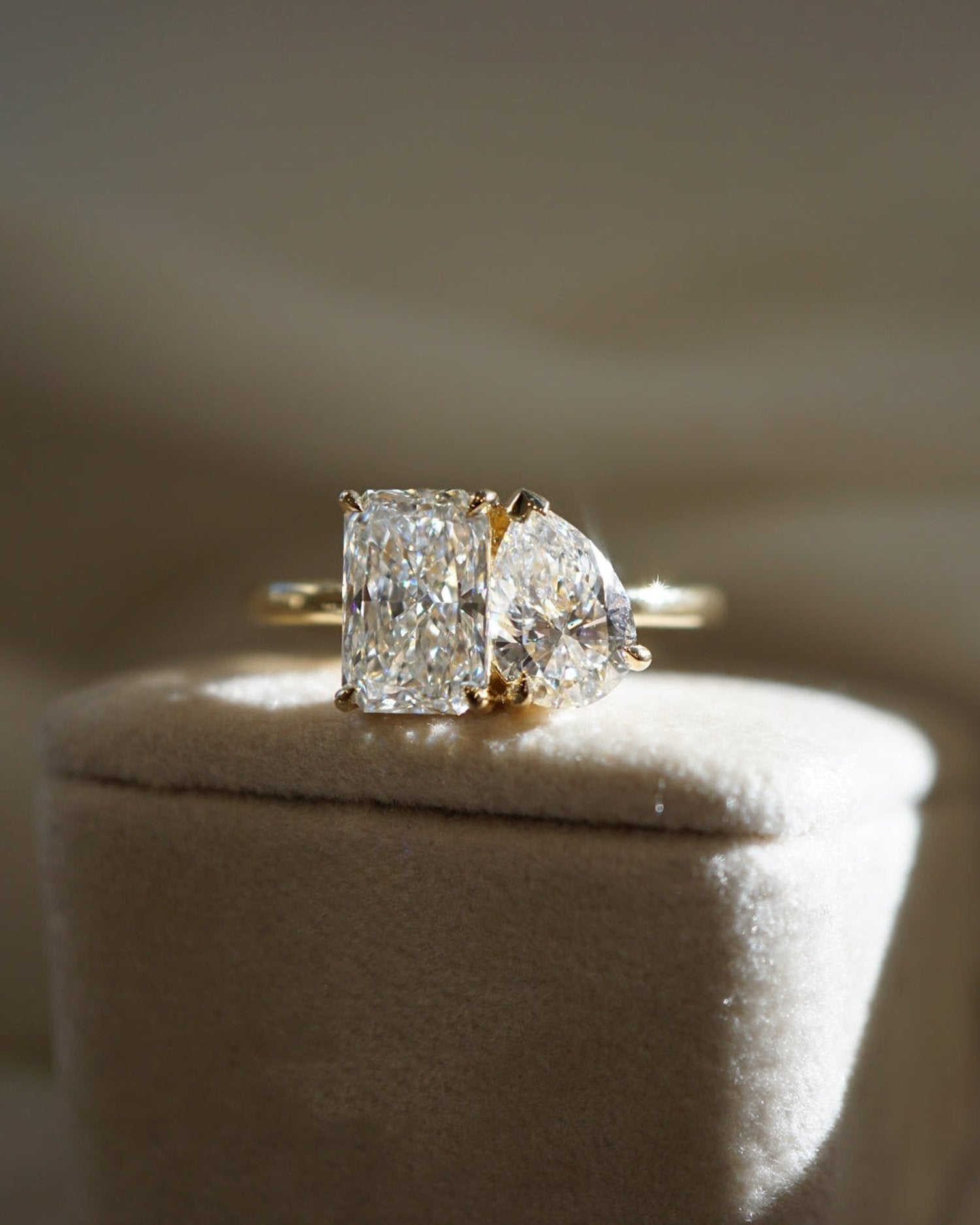 3.20 TCW lab grown diamond two stone engagement ring with radiant and pear cuts in gold, modern Toi et Moi style with elegant contrast