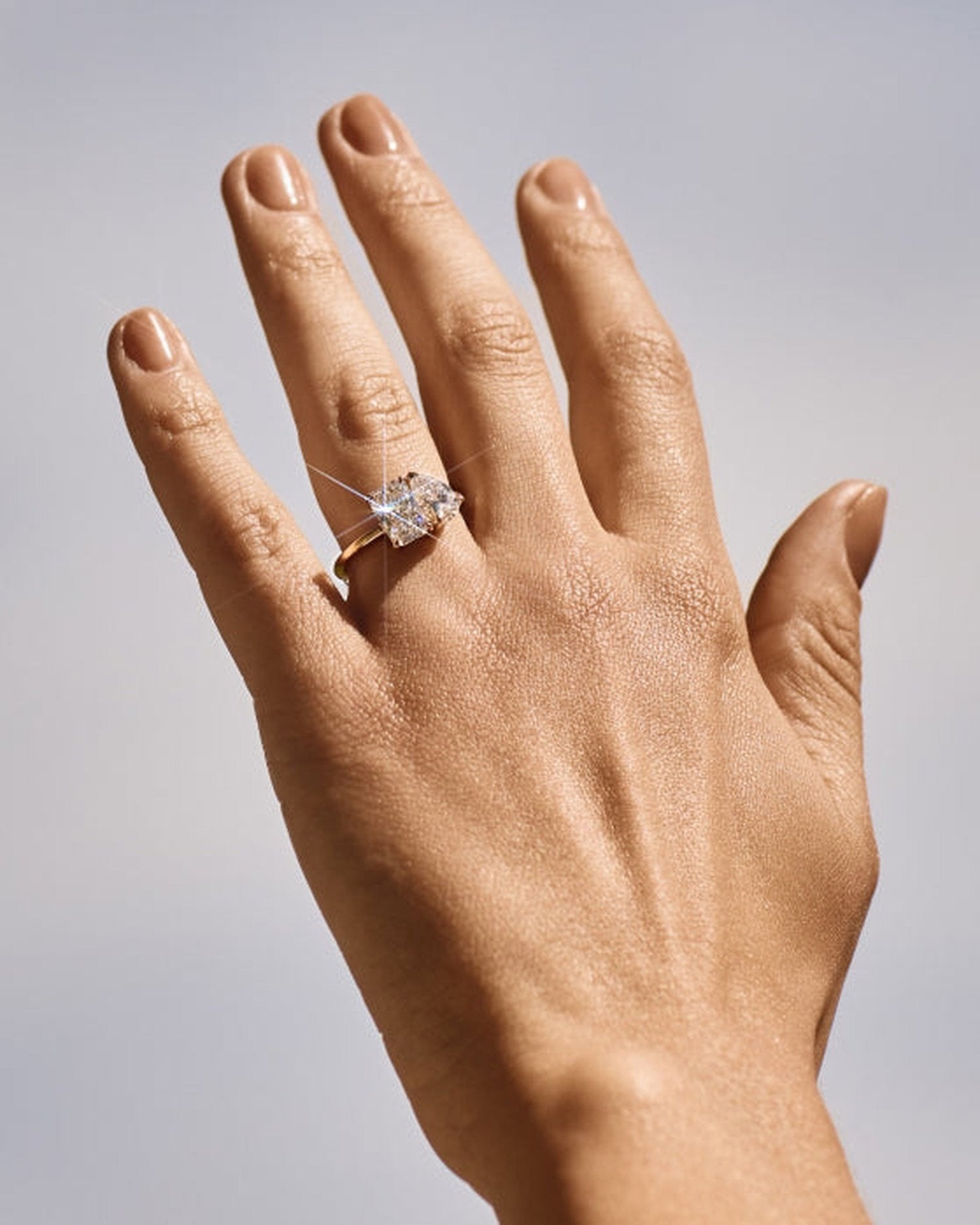 3.20 TCW lab grown diamond two stone engagement ring with radiant and pear cuts in gold, modern Toi et Moi style with elegant contrast