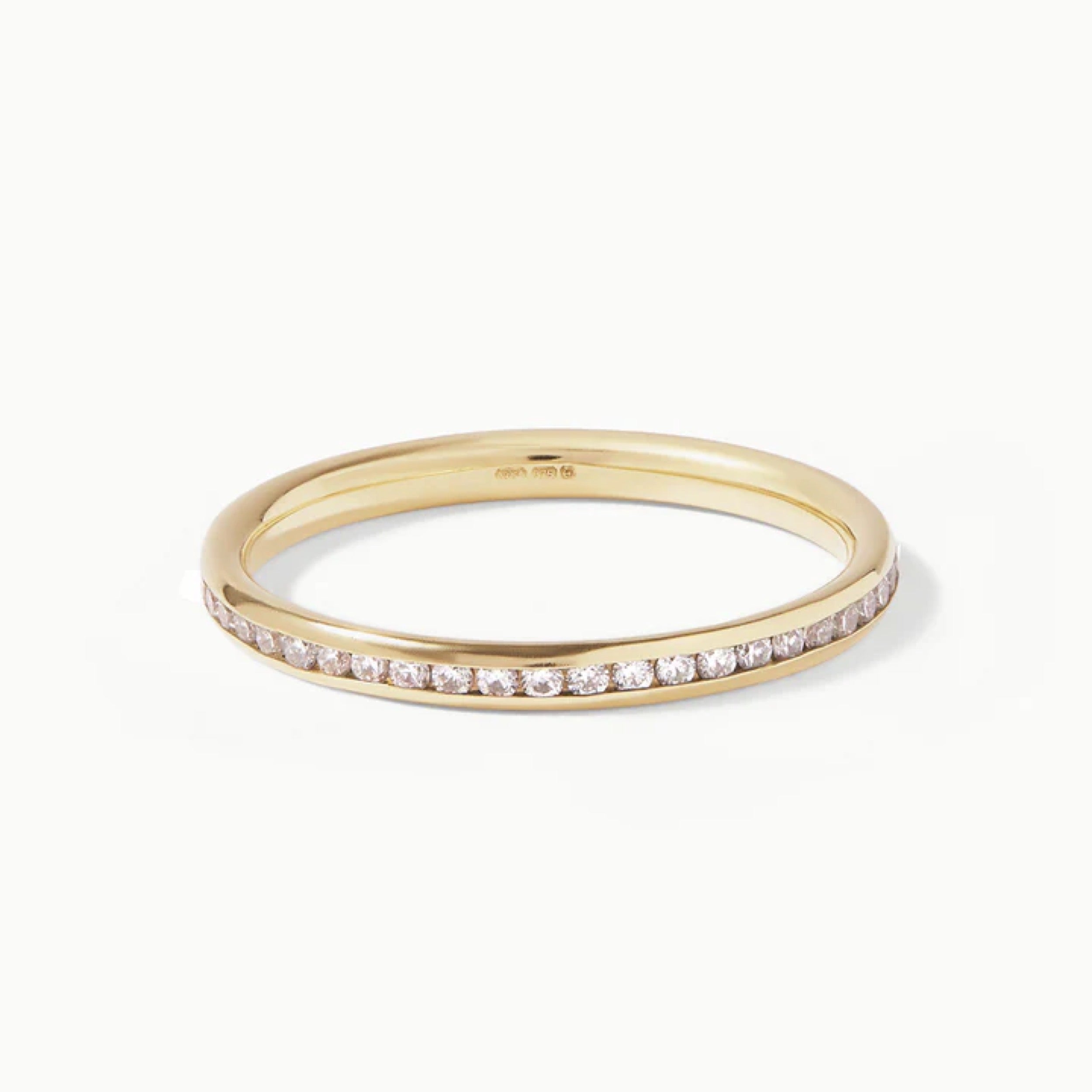 Round cut diamond wedding band featuring a curved design with CVD lab grown diamonds in a yellow gold setting.