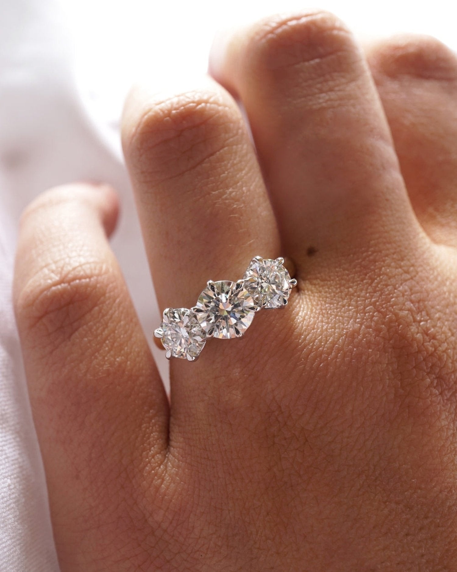 1.5–3.5 CT round cut lab grown diamond three stone engagement ring in gold, timeless bridal design with symbolic side stones