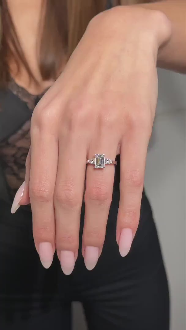 1.30–3.30 CT emerald cut lab grown diamond engagement ring with three stone setting and step-cut facets on a sleek metal band