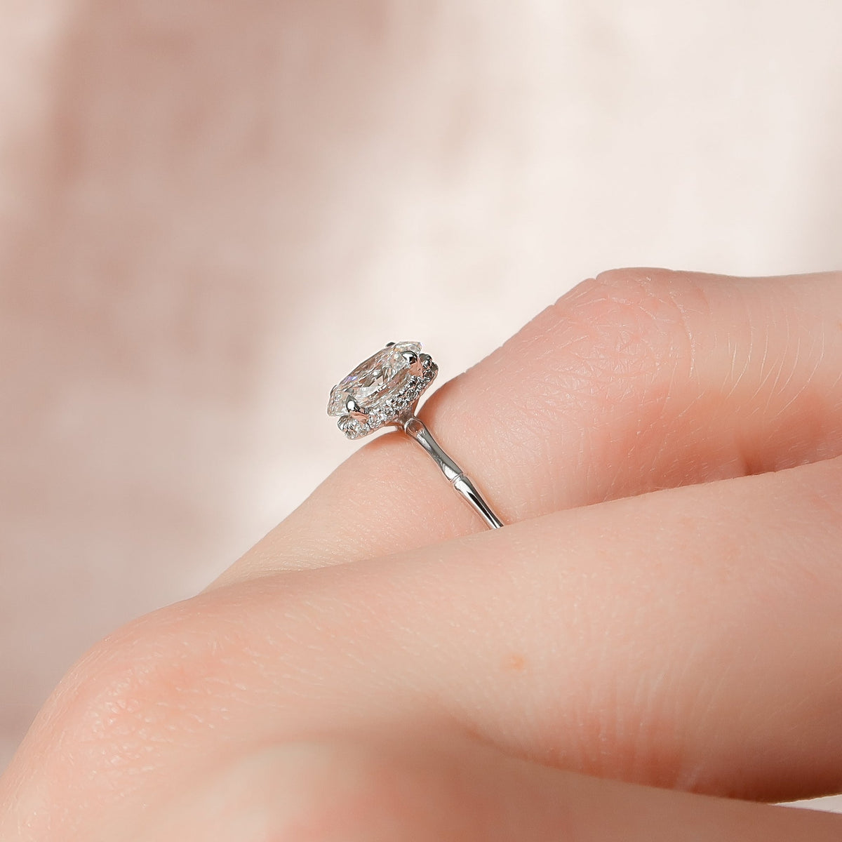 Oval cut CVD diamond engagement ring with hidden halo detail in platinum setting