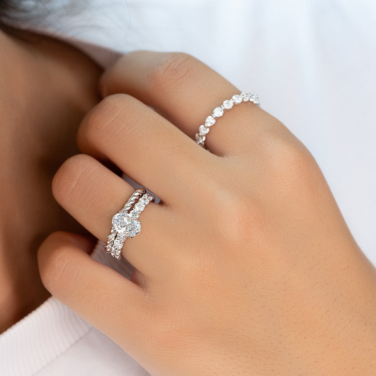 Oval cut CVD diamond hidden halo engagement ring with pave band in white gold