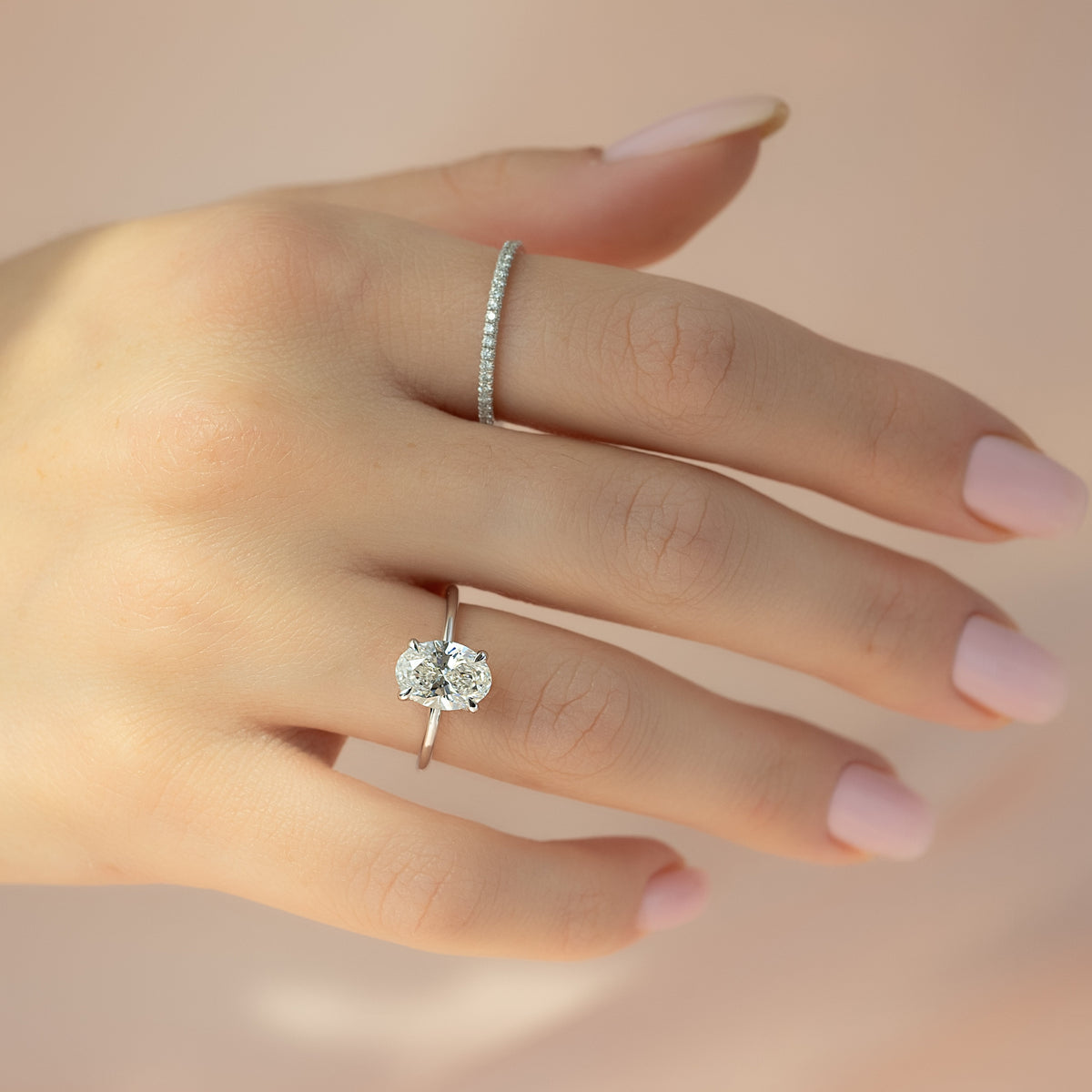 Oval cut CVD diamond hidden halo engagement ring with delicate band in white gold