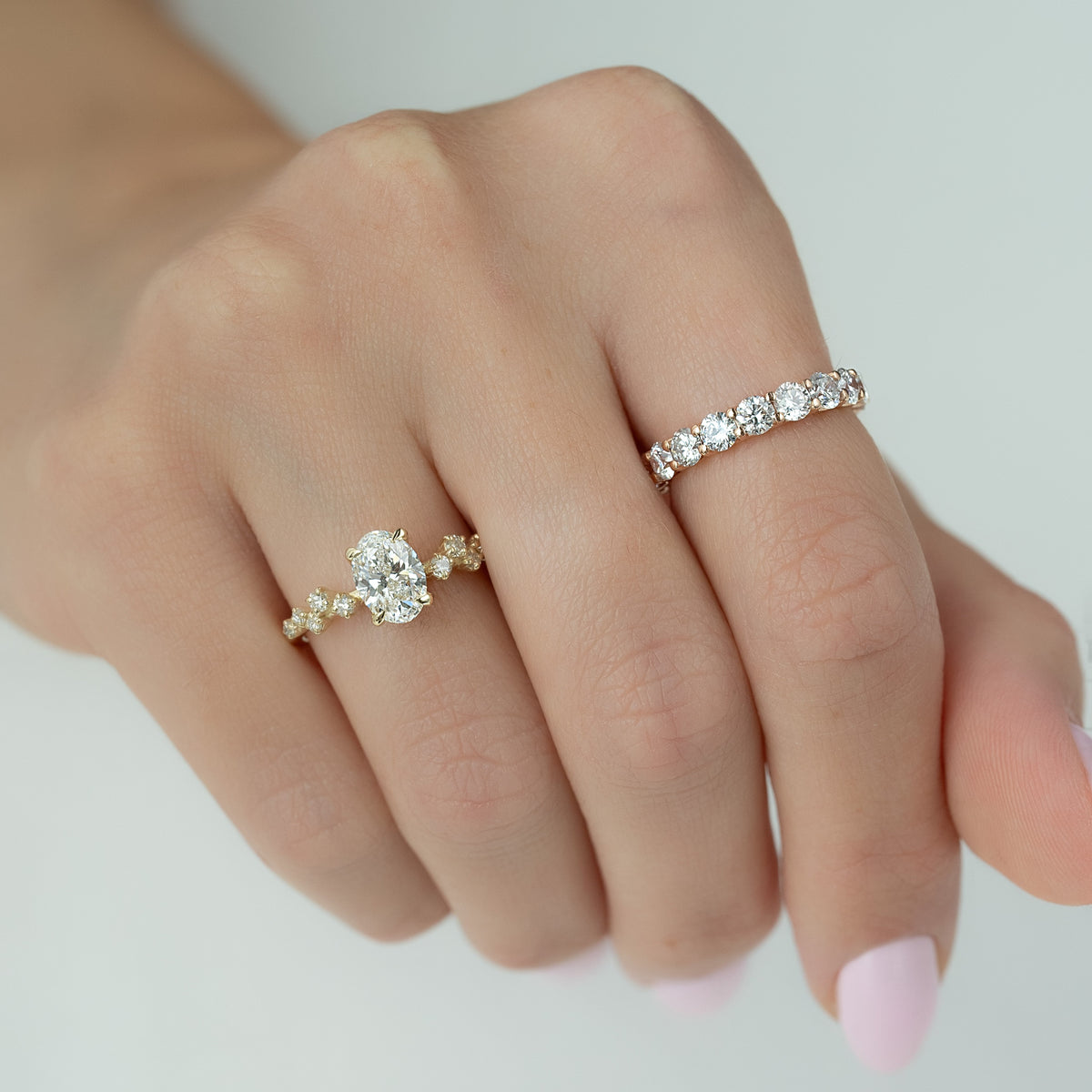 Oval cut CVD diamond engagement ring with hidden halo and pave diamond band in white gold