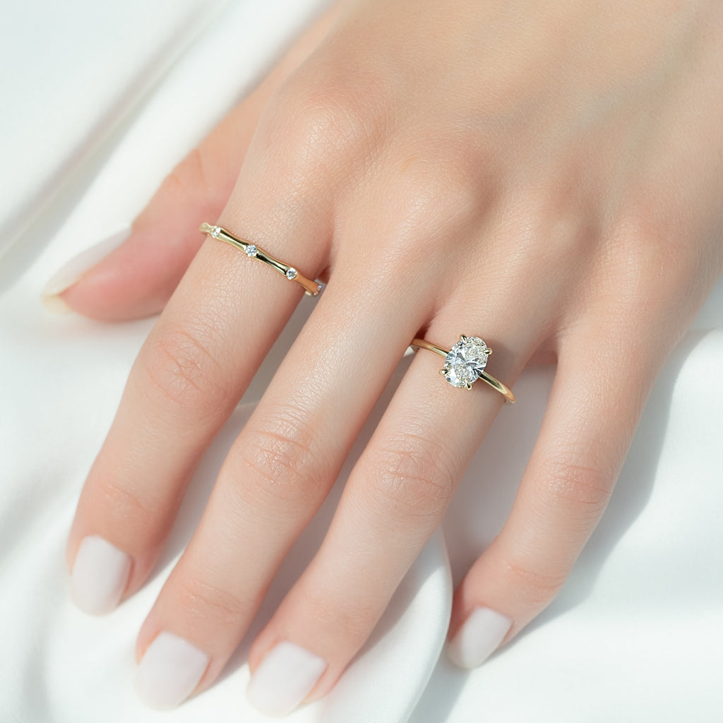 Oval cut CVD diamond hidden halo engagement ring with delicate band in white gold